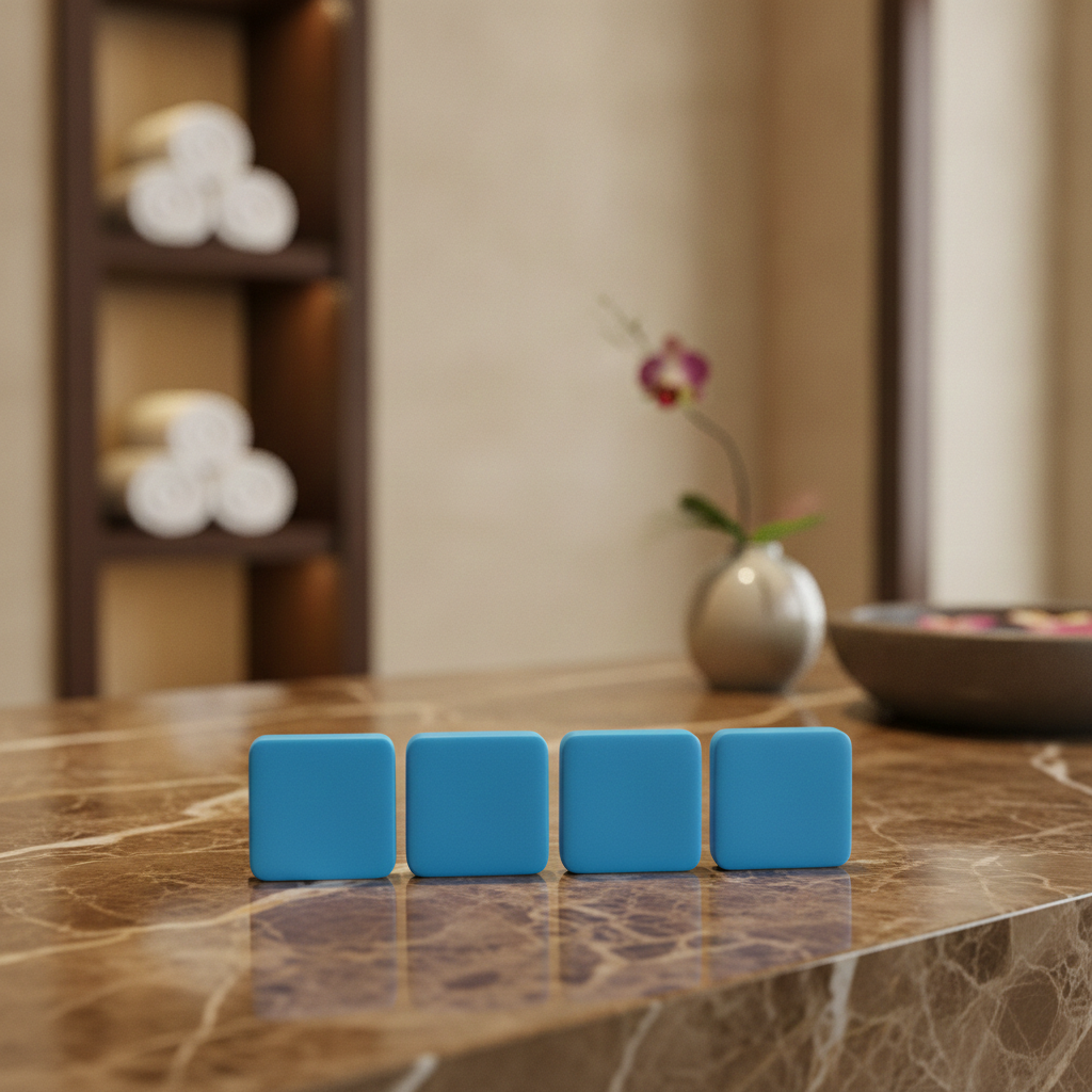 Four blue Stress Relief Shower Steamers lined up on a marble bathroom counter.