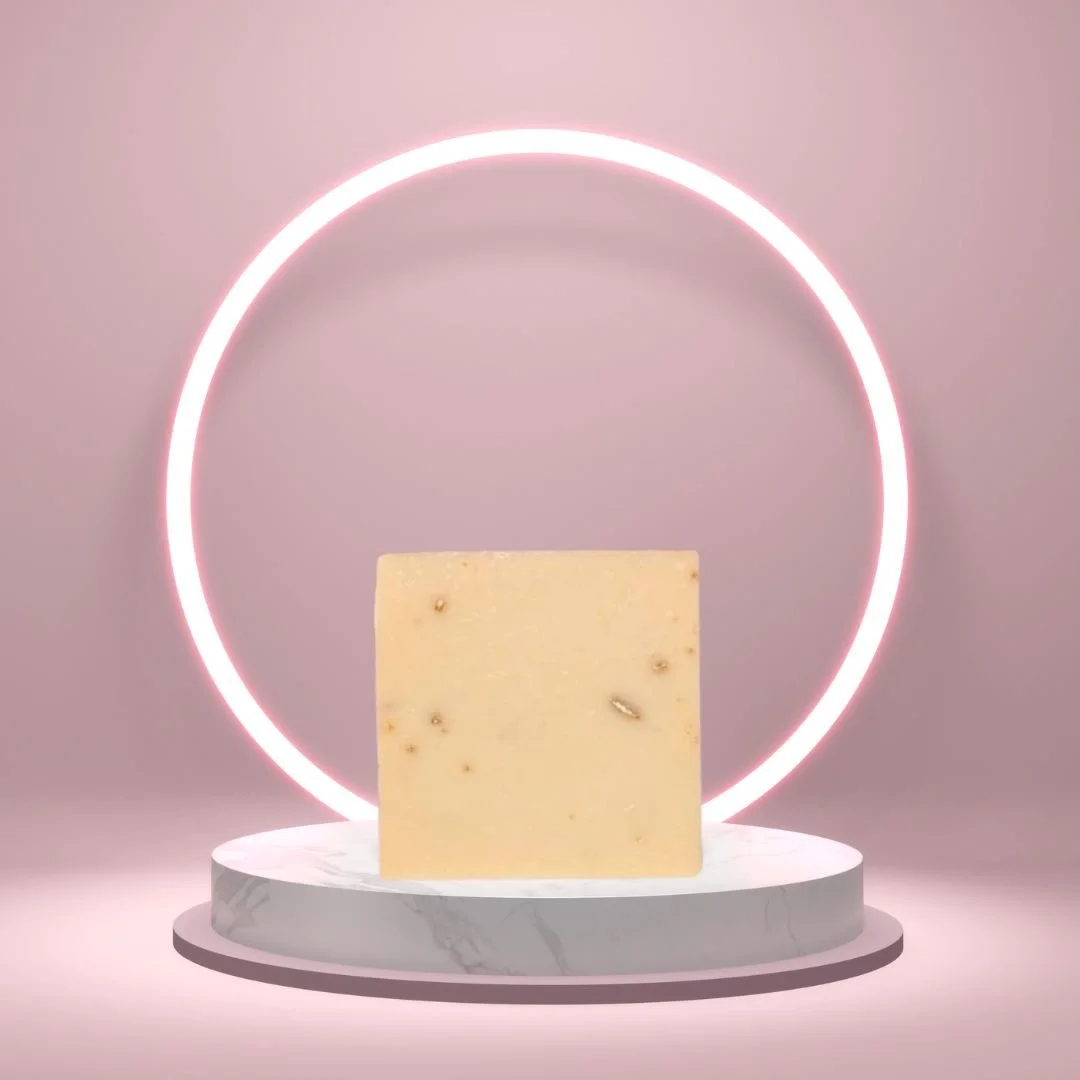 Cherry Almond Soap Bar on a white pedestal with a glowing pink circle background.