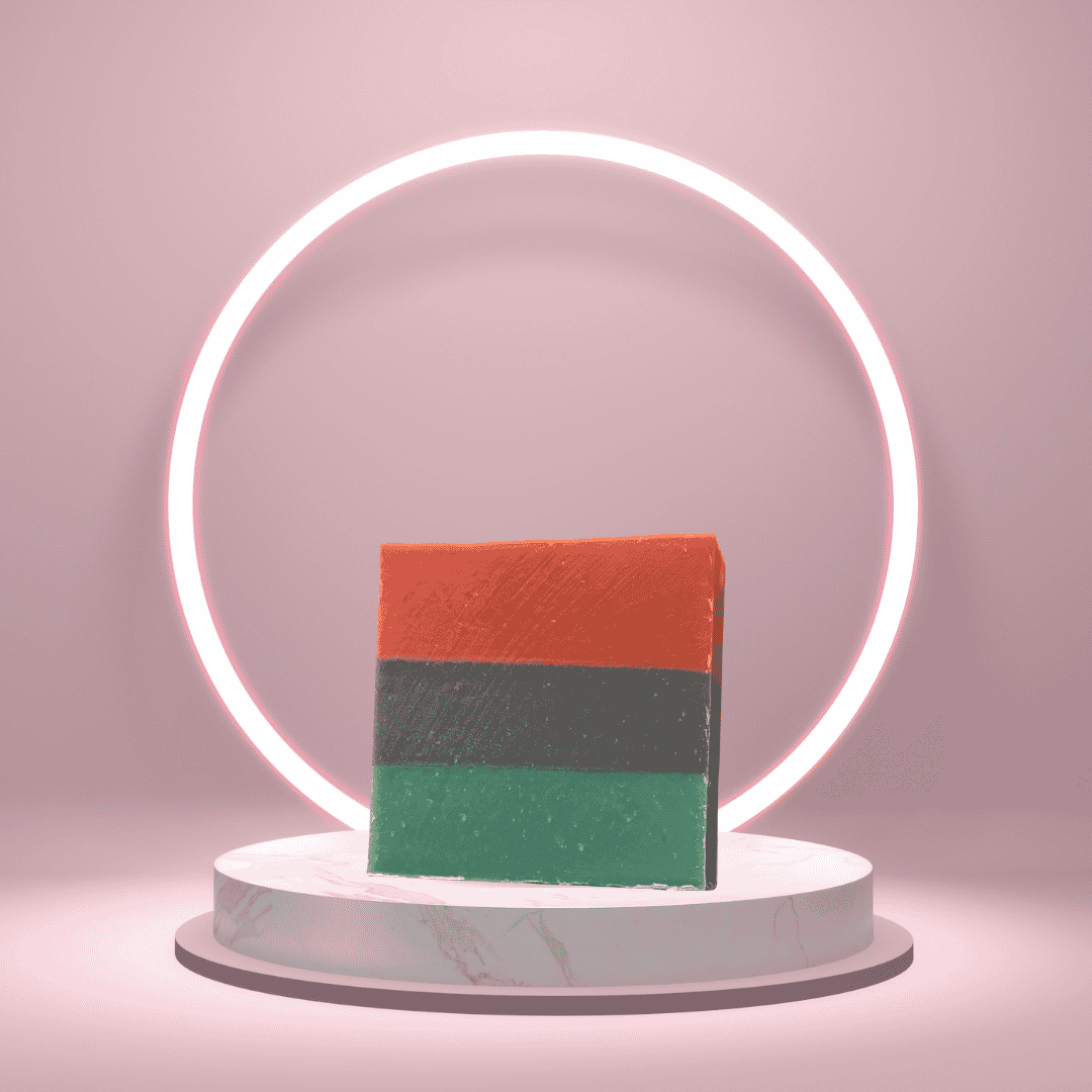 Liberation Lather soap with horizontal red, black, and green layers displayed on a pink pedestal