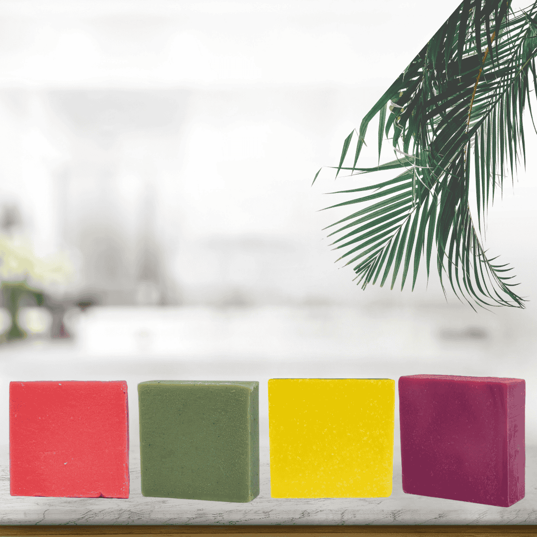 Bold and bright square soaps in red, green, yellow, and deep berry from Mama Aswan—photographed with breezy tropical flair for island-inspired skincare routines