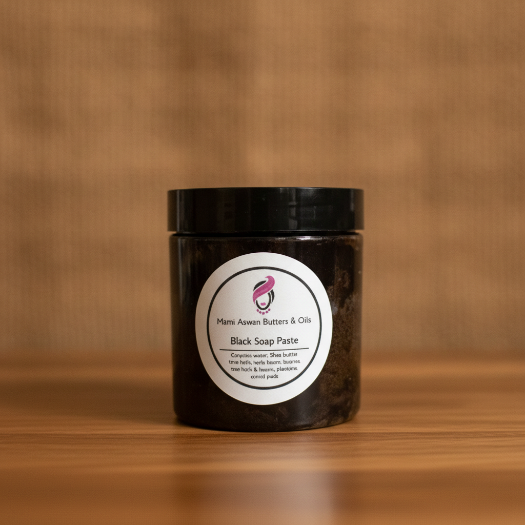 Raw African Black Soap Paste on a warm wooden surface against a softly textured brown background.