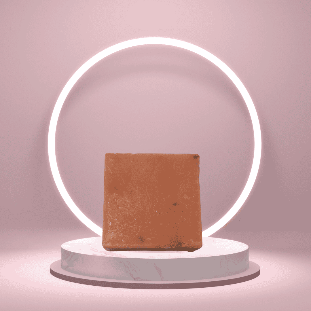 Bougie Auntie handmade soap bar on a pedestal with a glowing pink ring backdrop