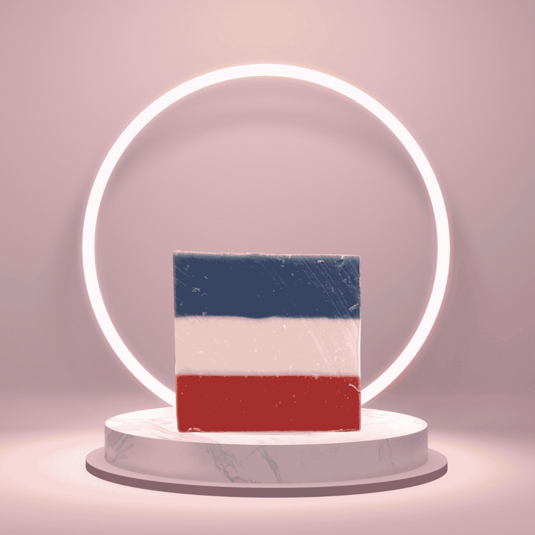 No Longer Bound Juneteenth-inspired soap with red, white, and blue layers on a pink pedestal