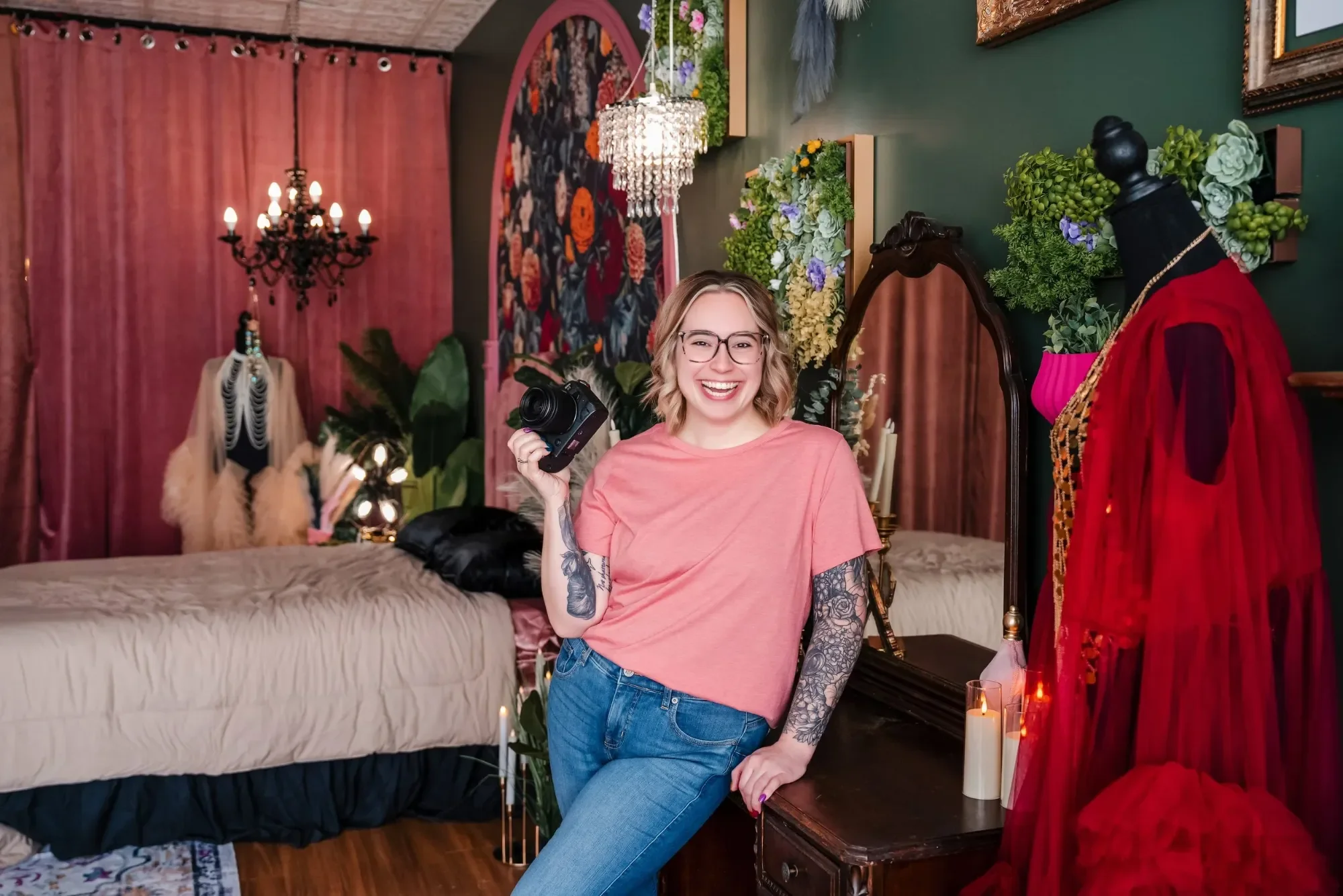 professional headshot of Samantha smiling & holding her camera