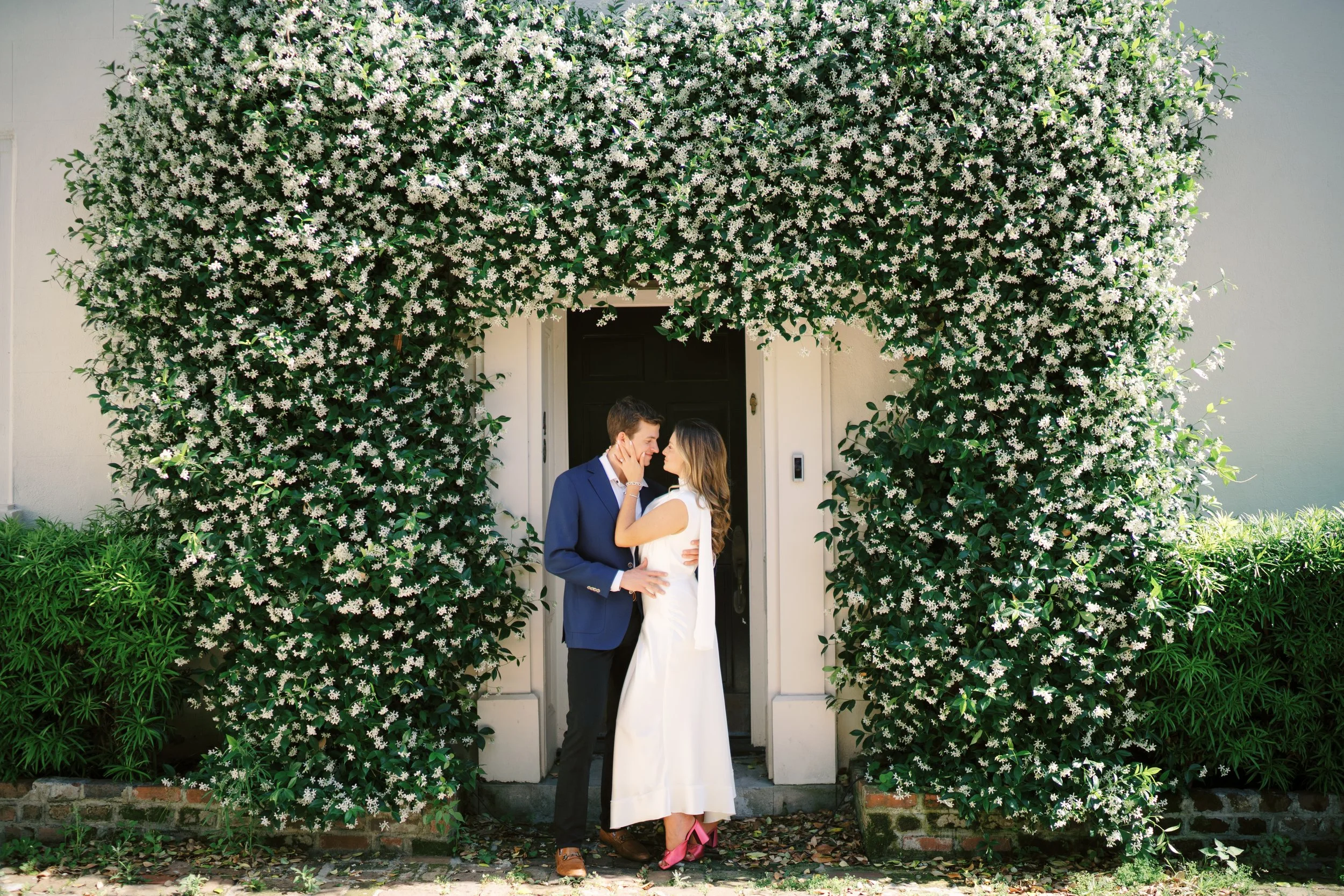 ivy-covered wall in Charleston used as a backdrop for engagement photos