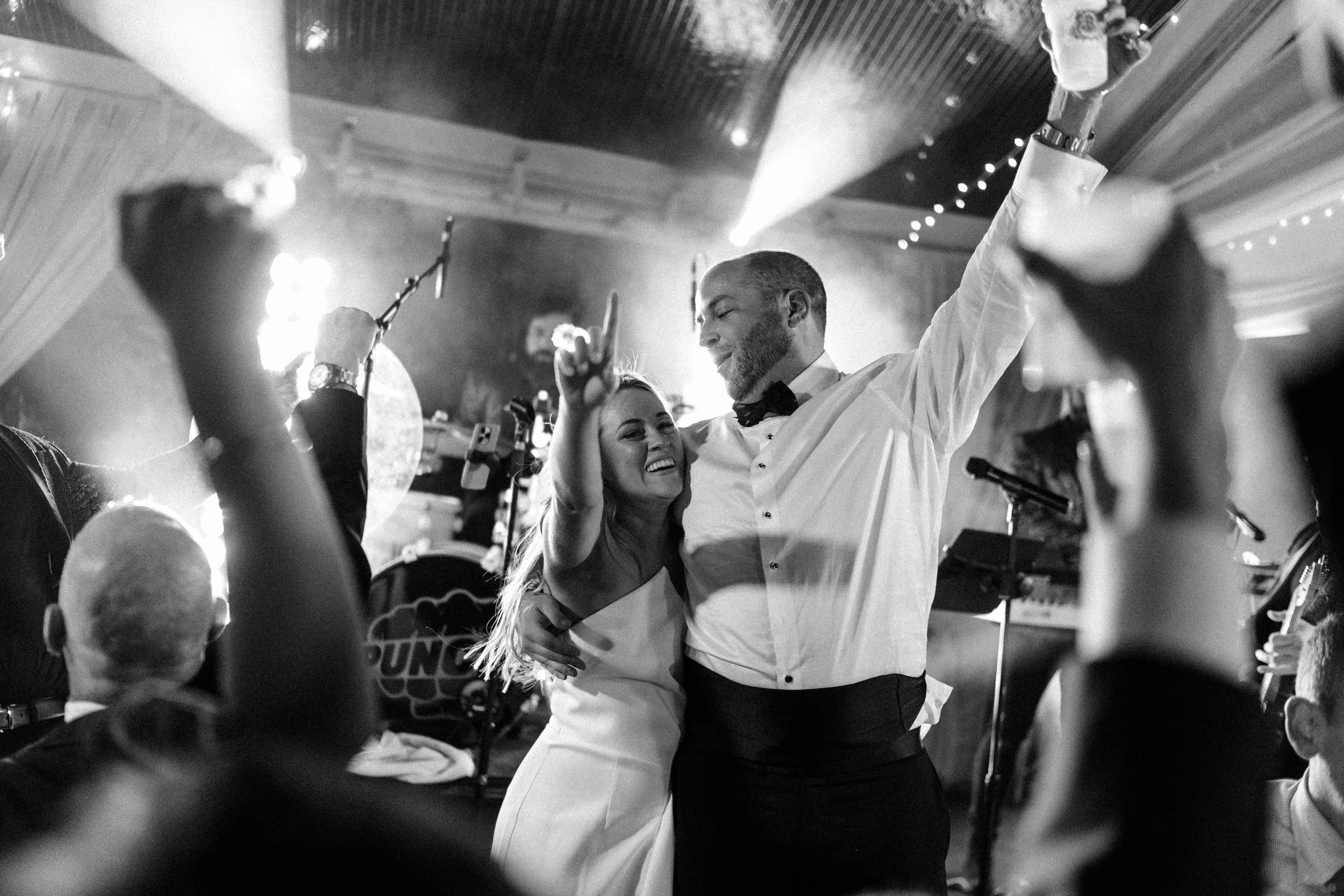 Bride and groom on stage dancing at their wedding reception at Hotel Domestique in Travelers Rest, SC