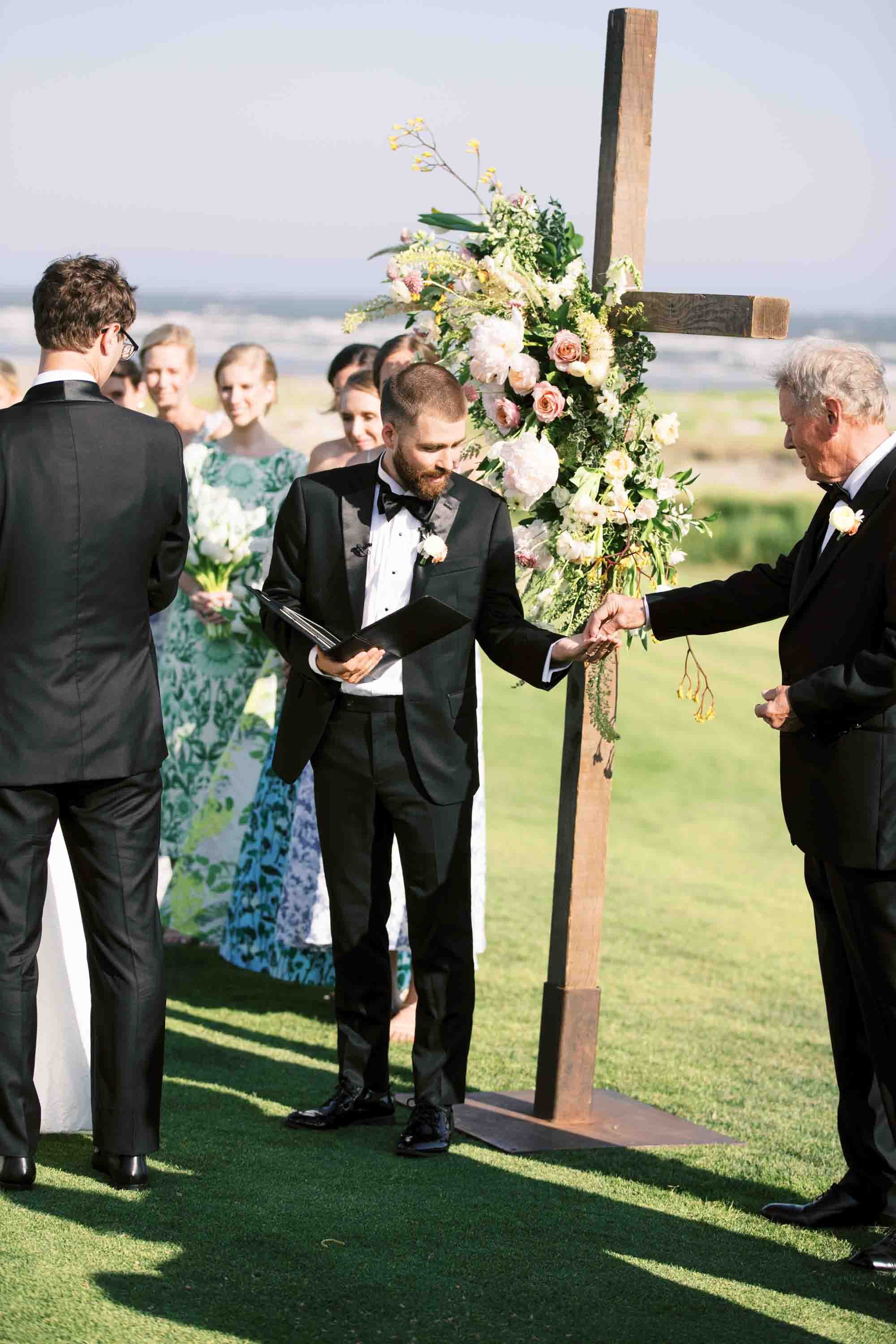 Close-up moment during the wedding ceremony with officiant and couple exchanging vows at Kiawah Island