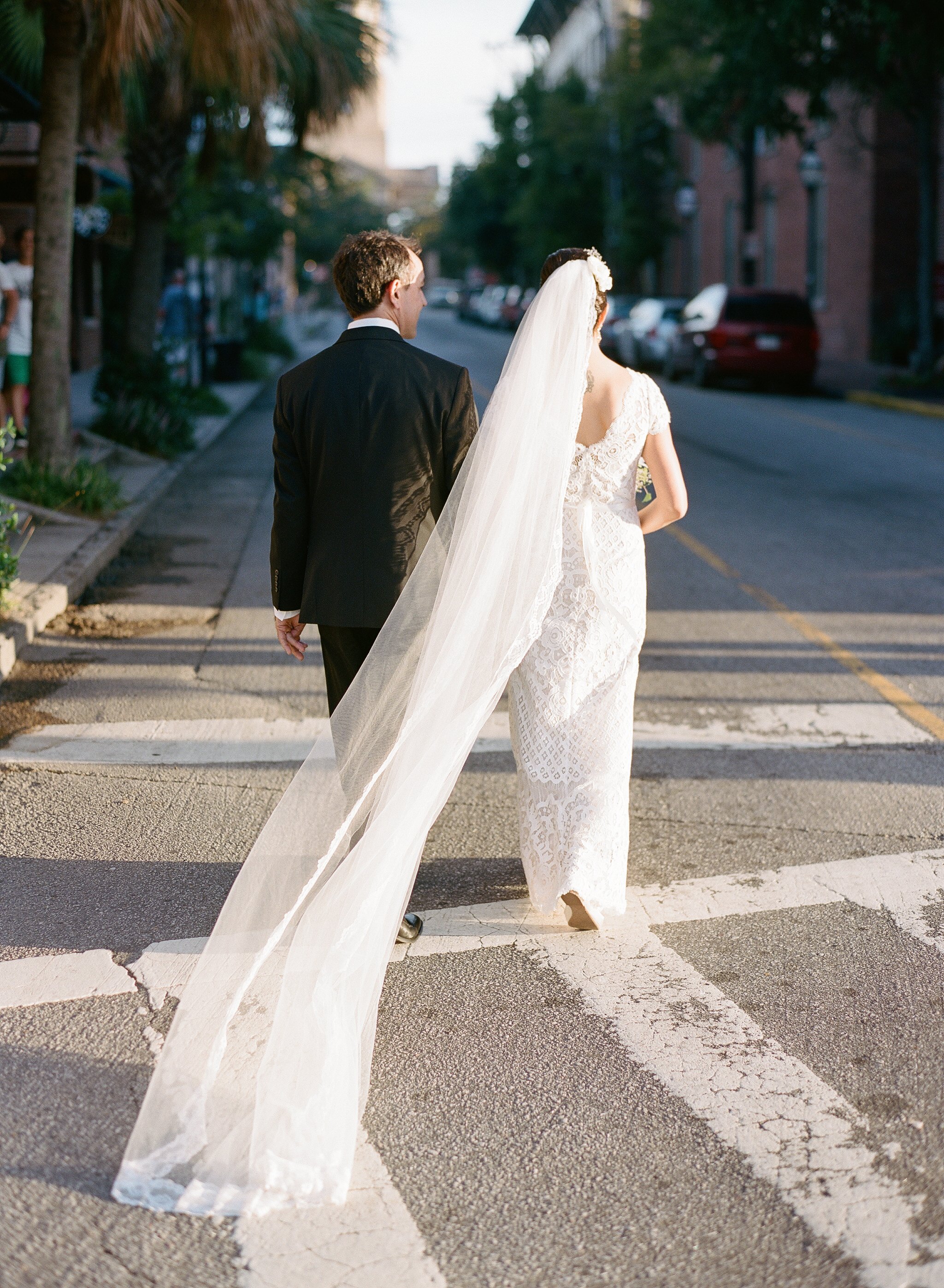 Charleston elopement photographer, Lauren Jonas, photographed bride and groom walking downtown Charleston