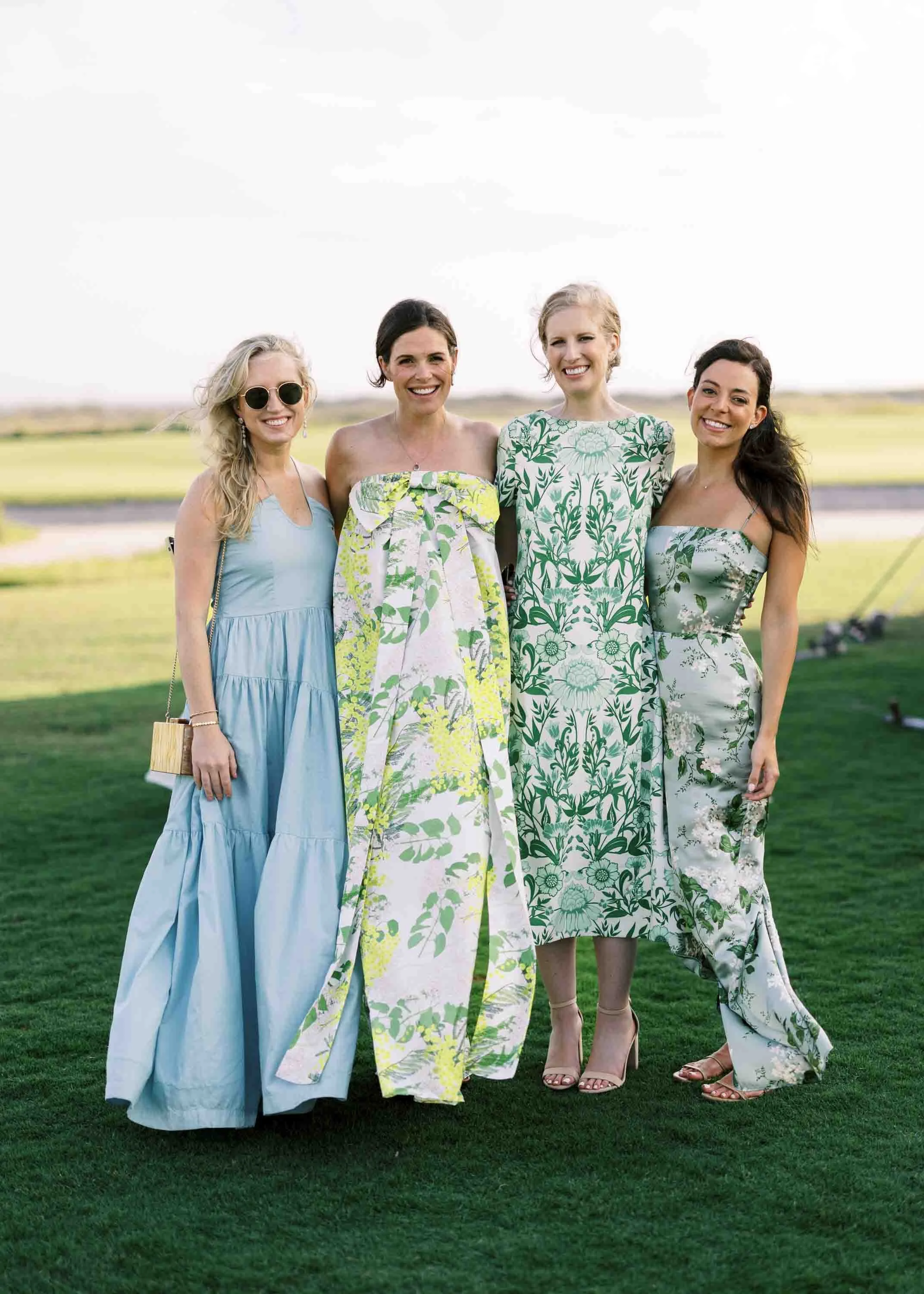 Group of wedding guests posing together on the lawn at the Ocean Course on Kiawah Island