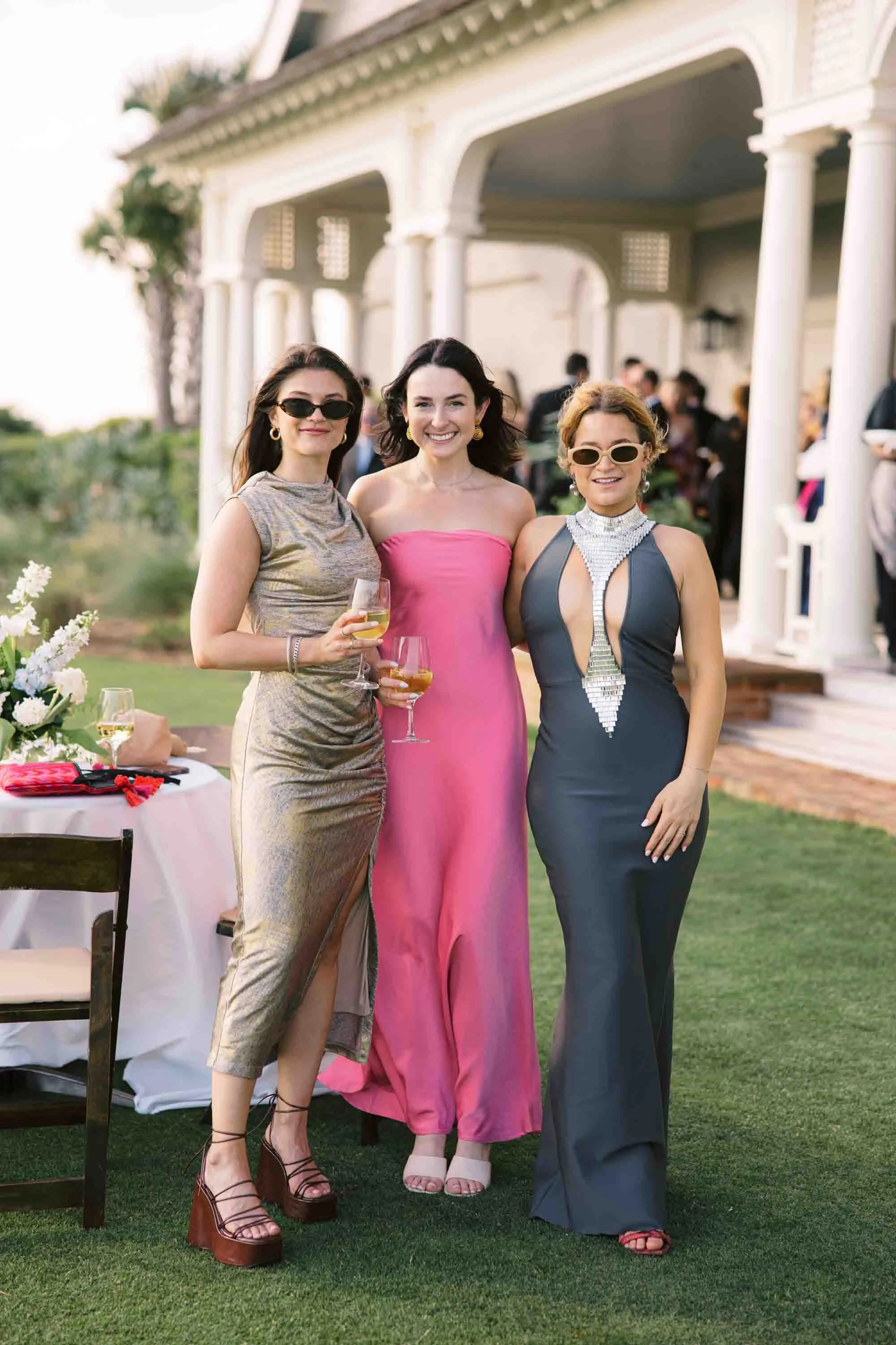 Wedding guests dressed in formal attire standing outside during cocktail hour at Kiawah Island