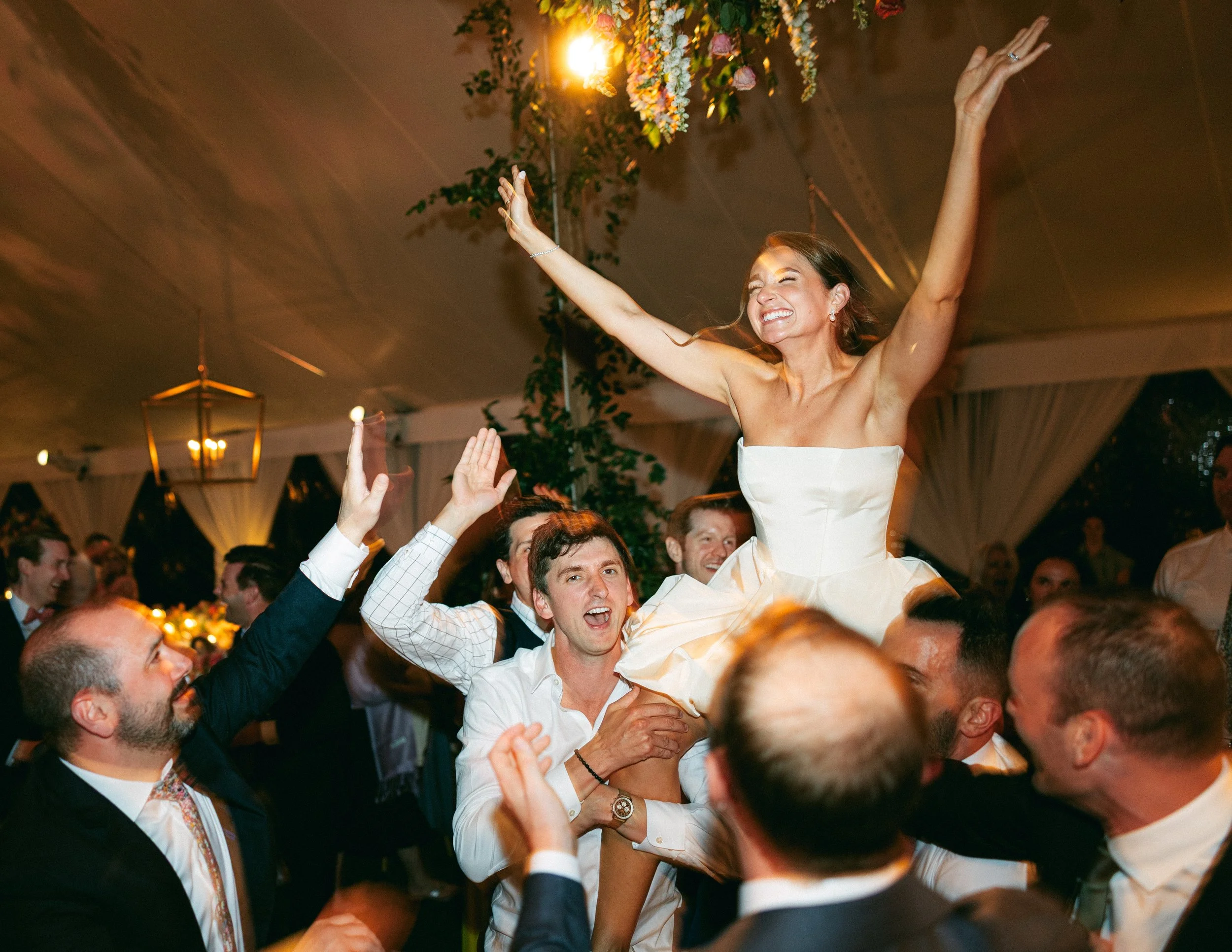 Bride being lifted during wedding reception at Ocean Course on Kiawah Island sc