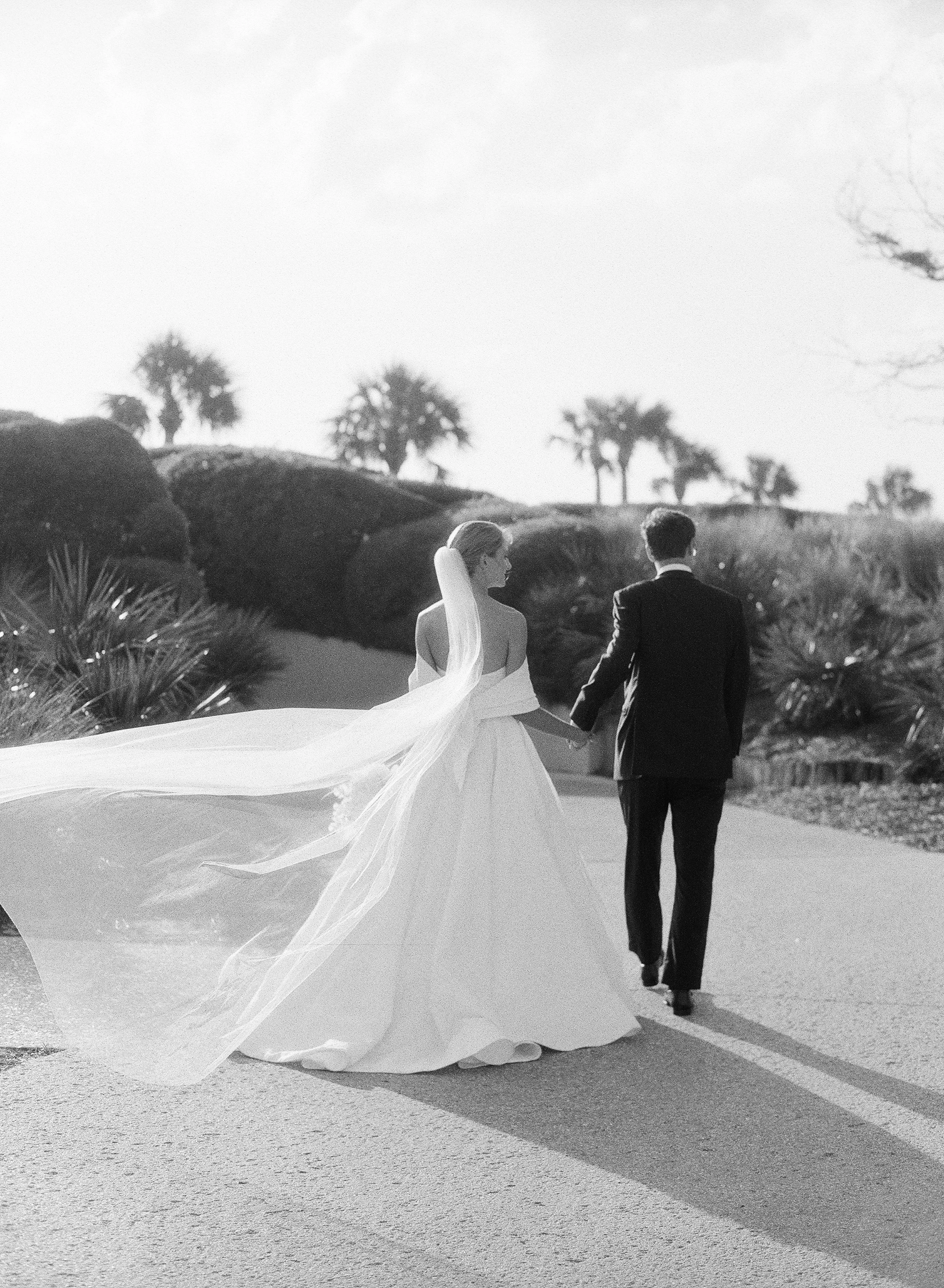 windy bride and groom portraits at the ocean course