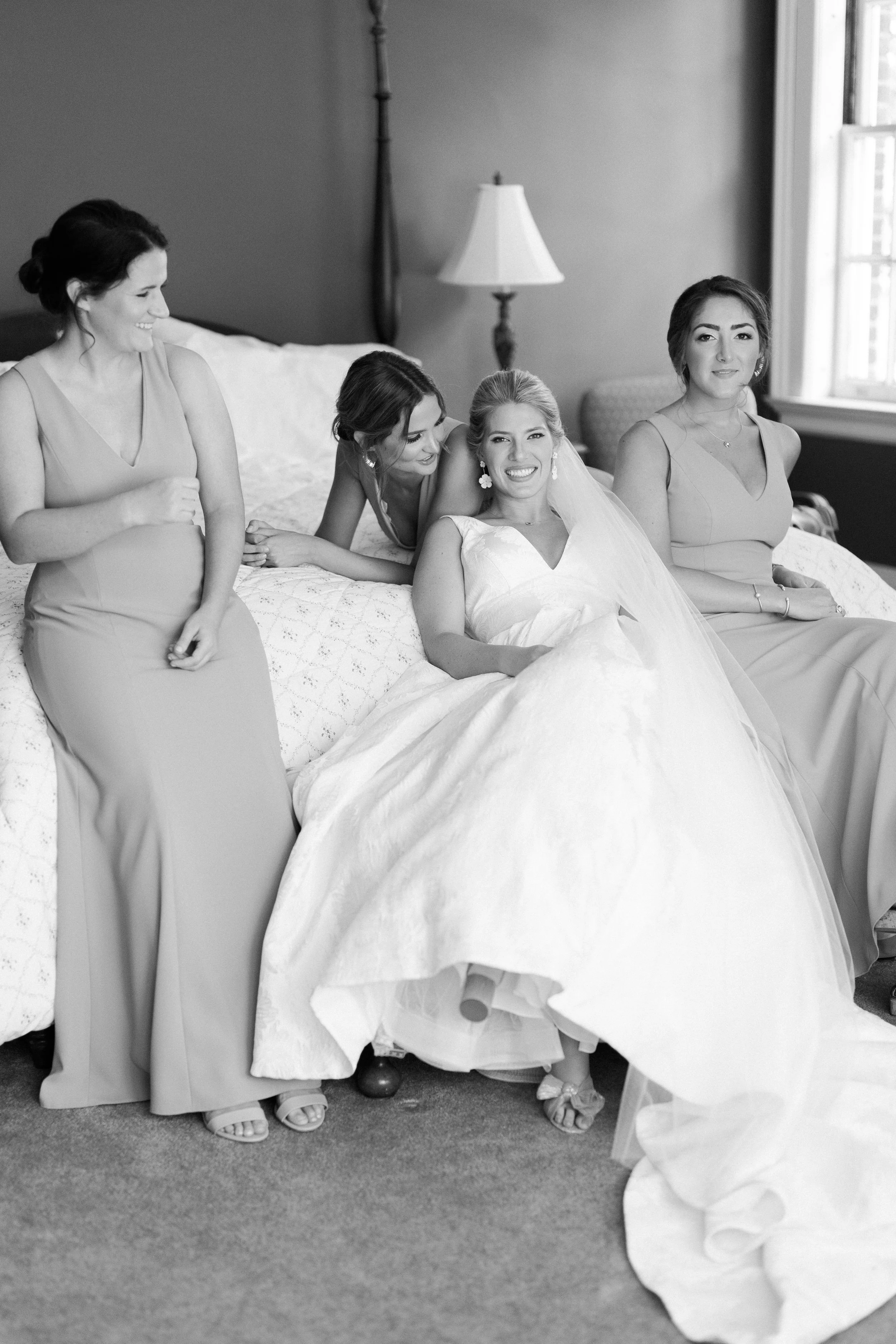 Candid bride getting ready moment with bridesmaids at Belmont North Carolina wedding