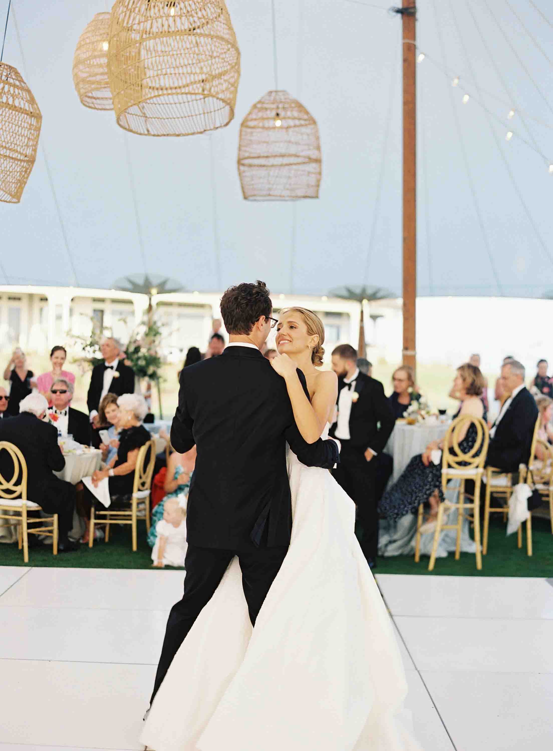 Bride and groom sharing their first dance under a tent at their Kiawah Island wedding reception