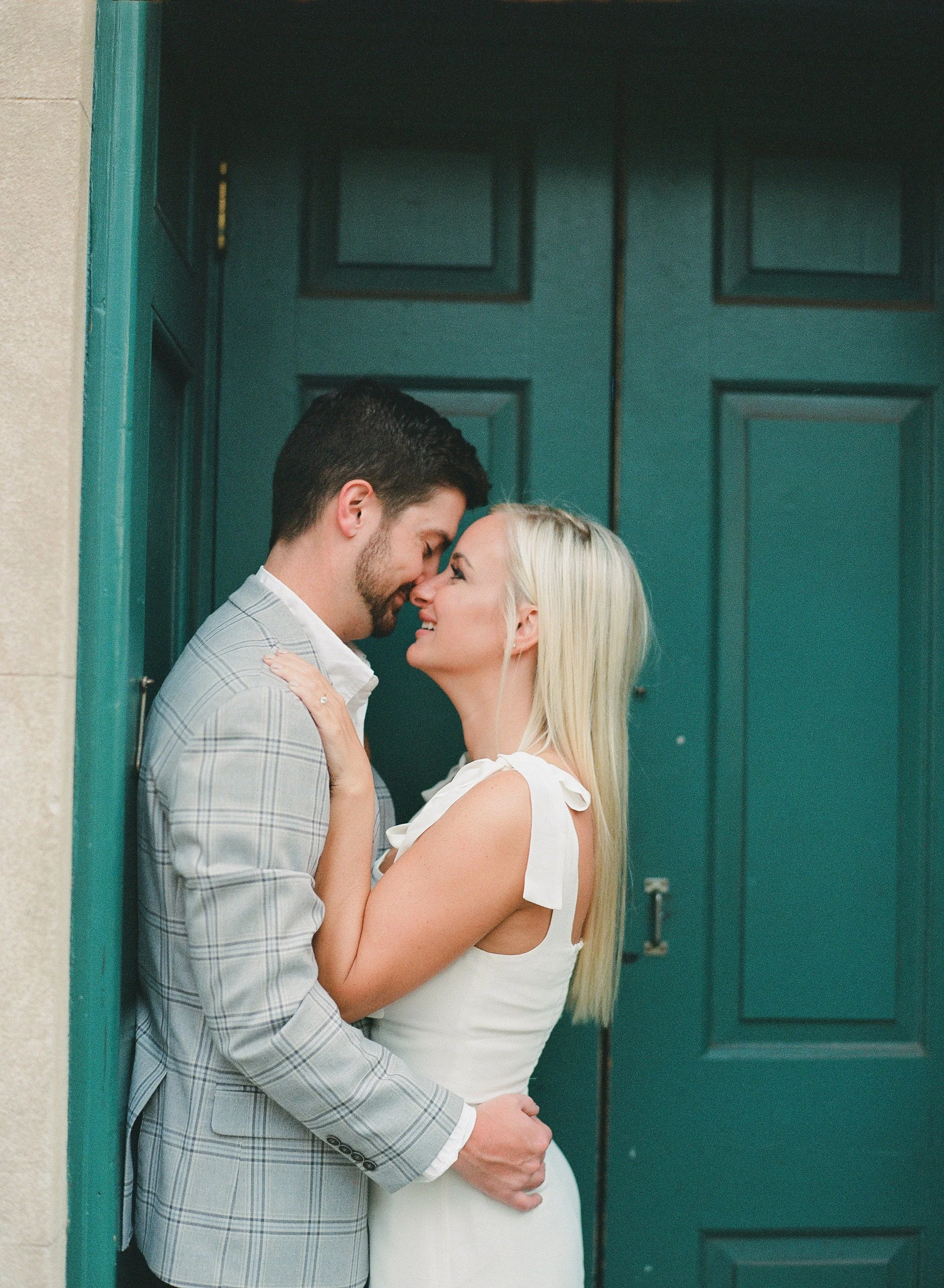 close up engagement photos on Queen Street Charleston in front of green historic door