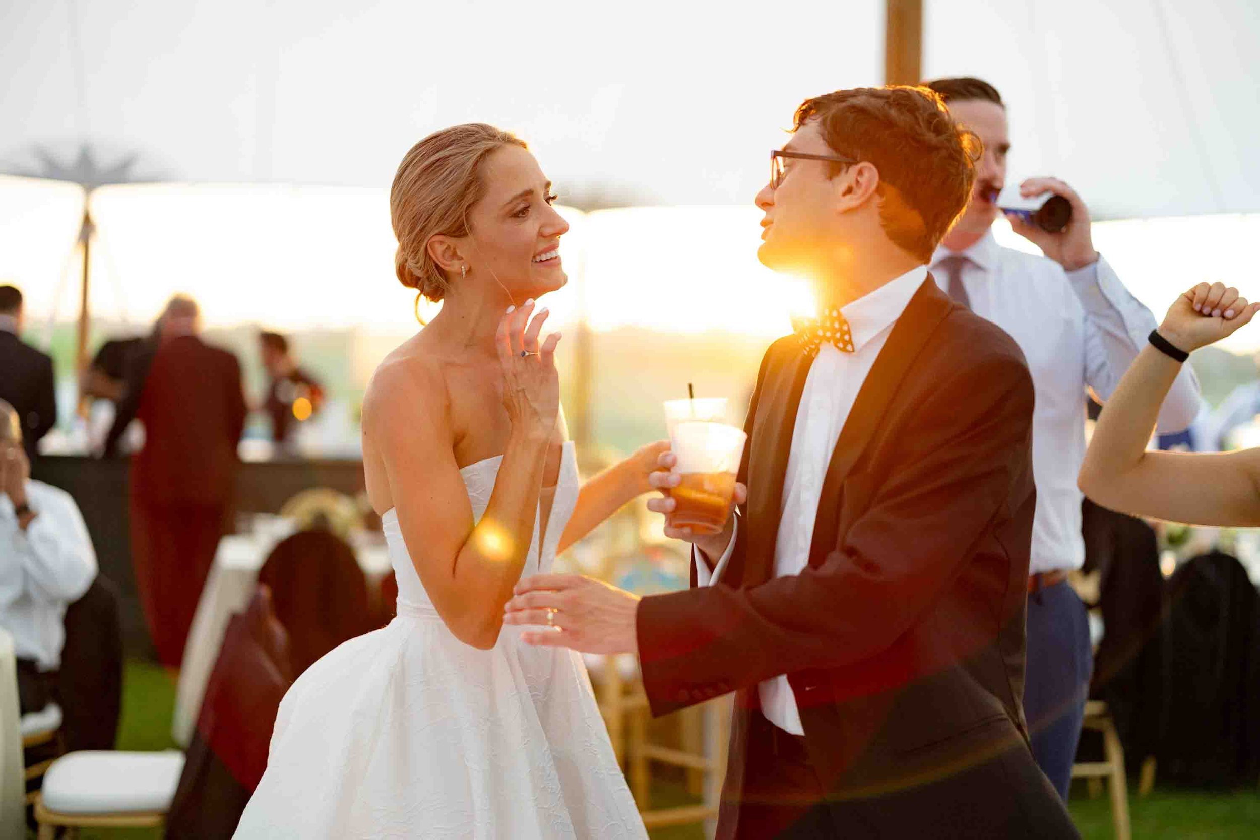 Bride and groom dancing together with golden sunset light at their Ocean Course wedding
