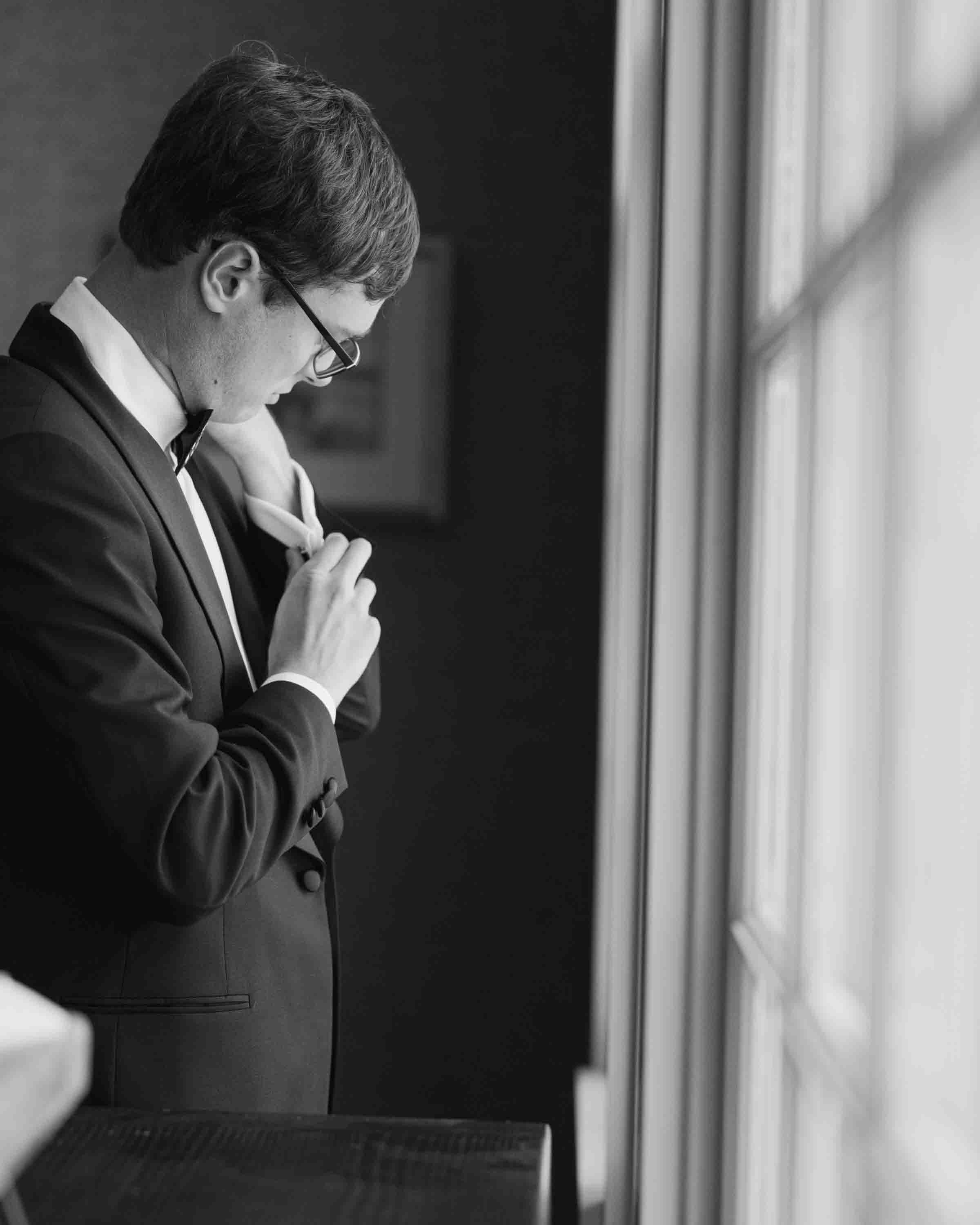 groom getting ready window light kiawah island wedding ocean course groom portrait