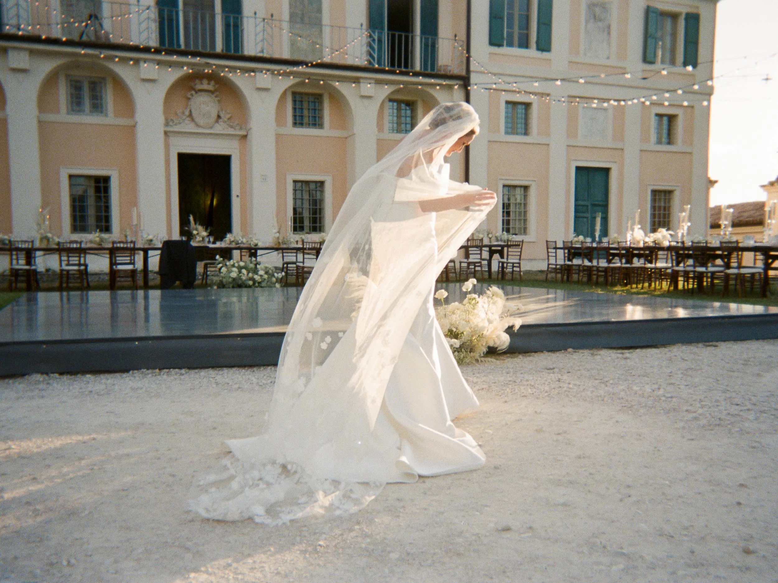 Bride walking through the reception space during a destination wedding at Villa Pianciani in Umbria, Italy.