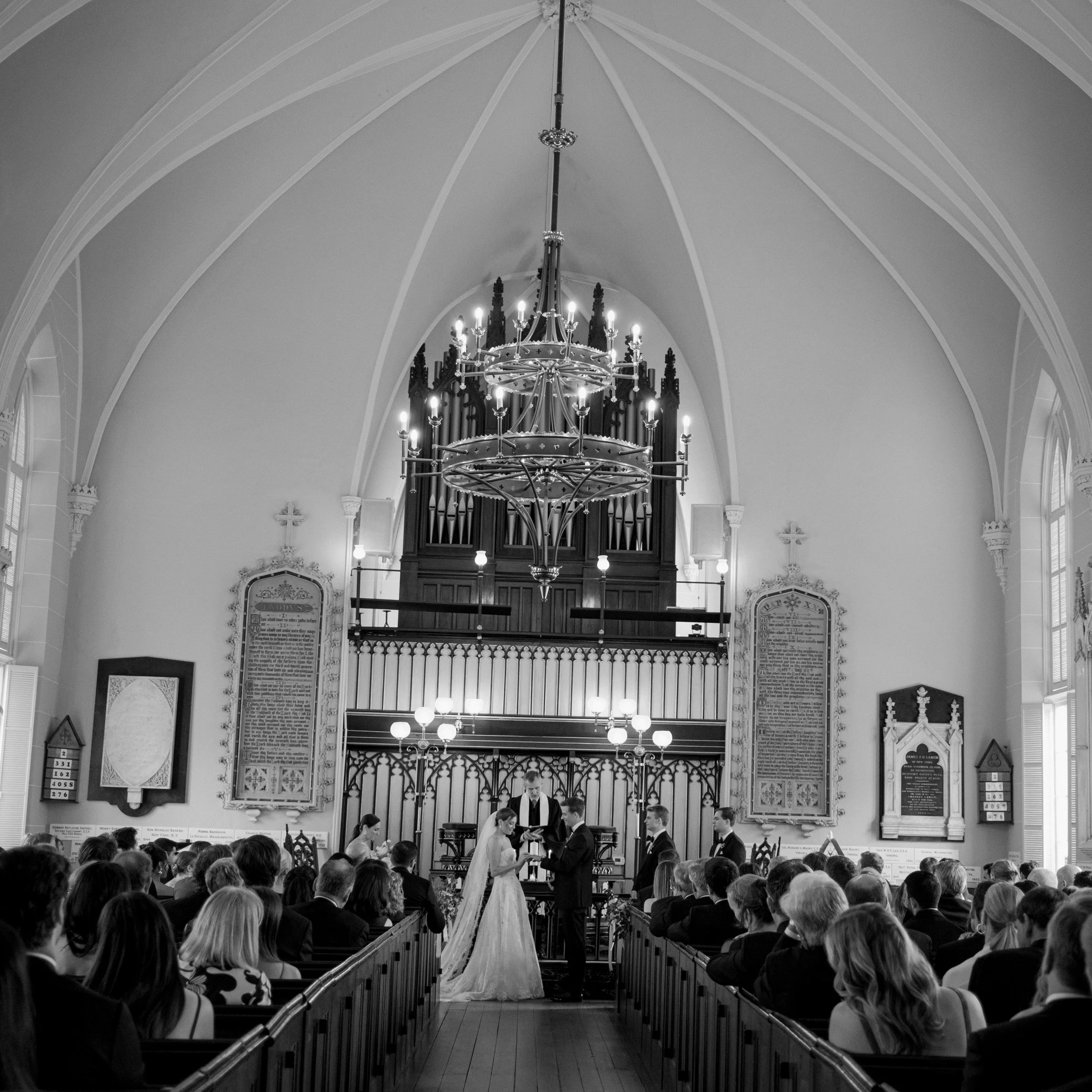 Wedding ceremony at French Huguenot Church in Charleston South Carolina with bride and groom at altar