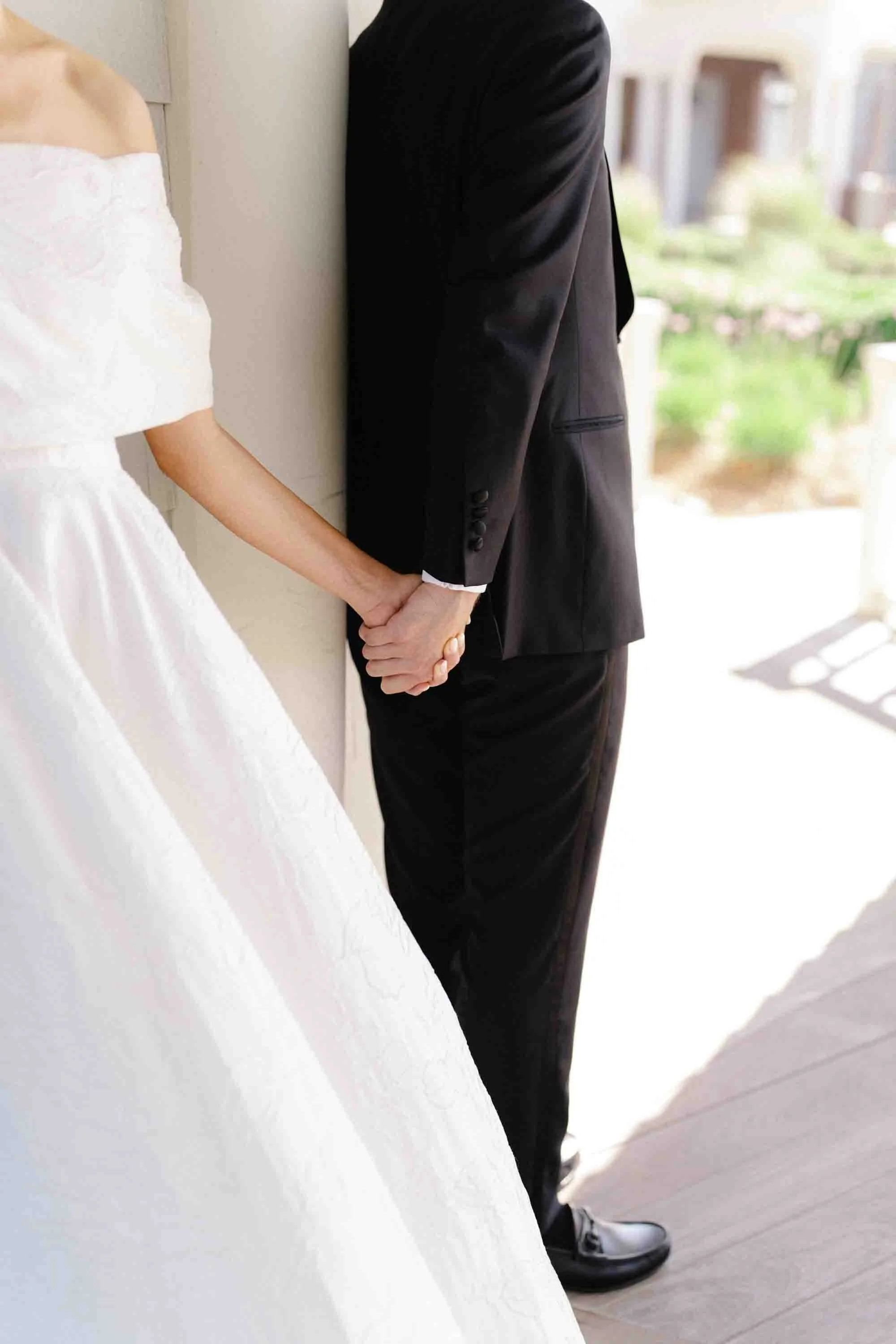 bride and groom hold hands during first look ocean course kiawah island wedding photographer