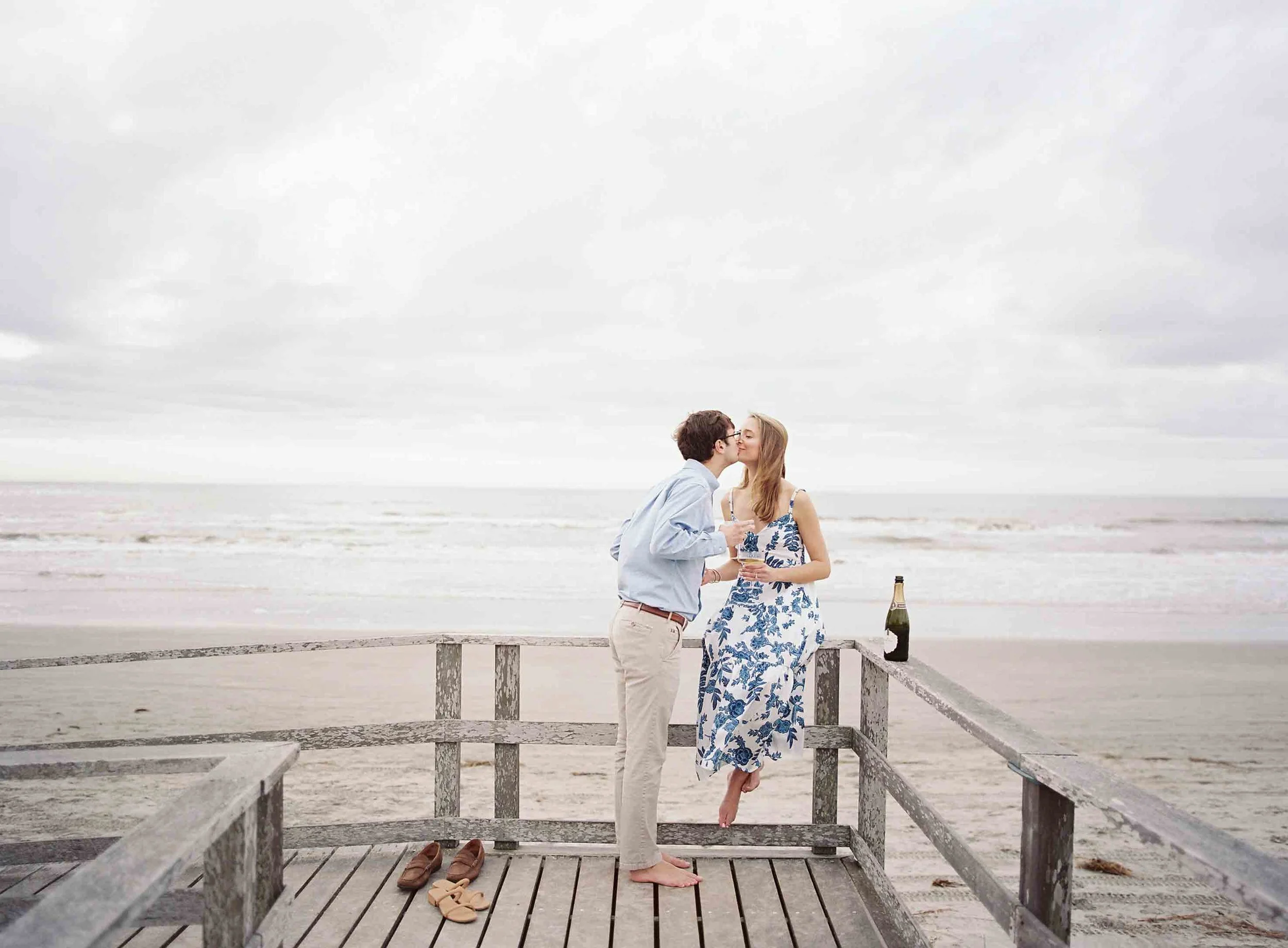 engagement photos at the Ocean Course on Kiawah Island with boardwalk and ocean views