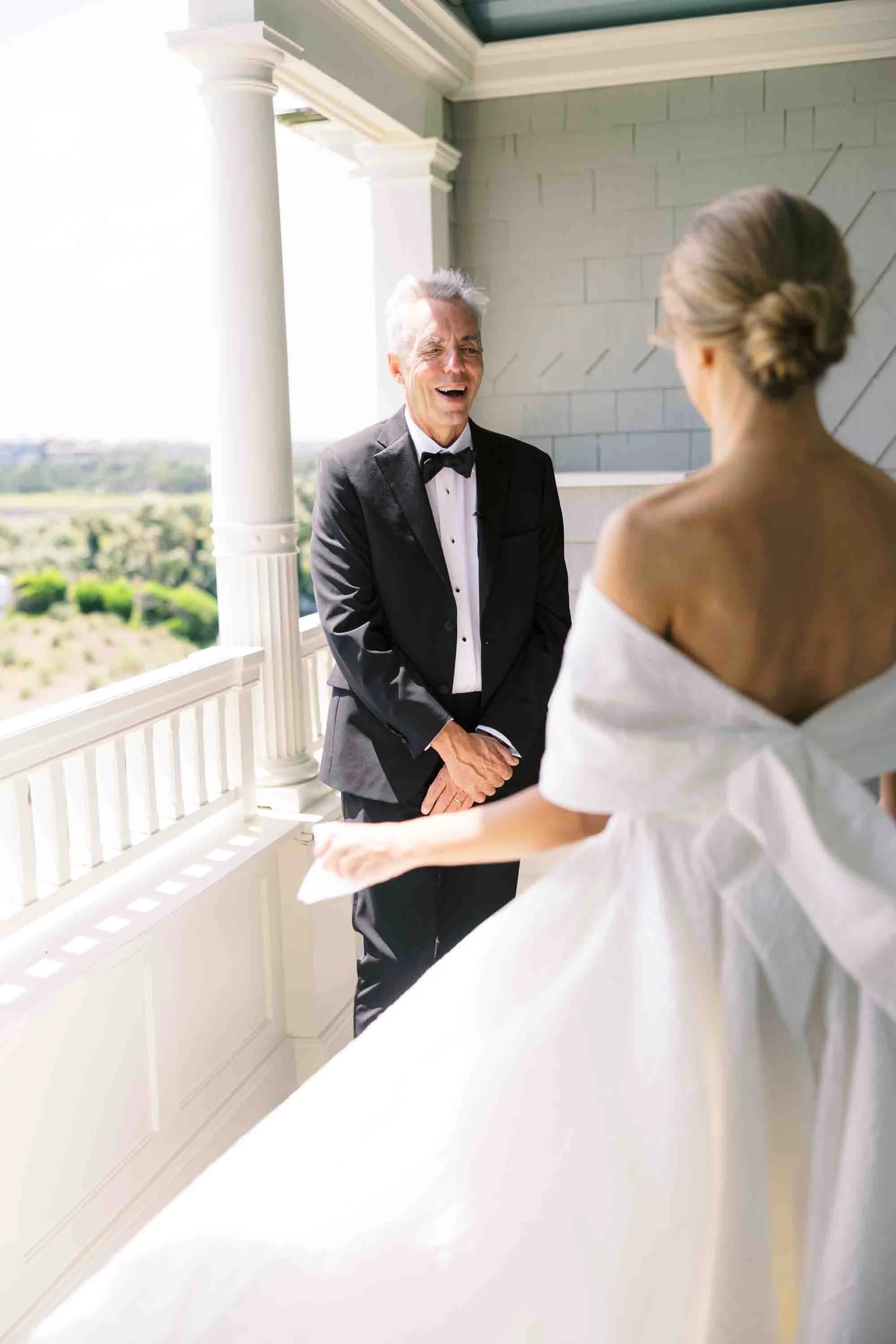 Father reacting emotionally as he sees the bride on a balcony at a Kiawah Island wedding