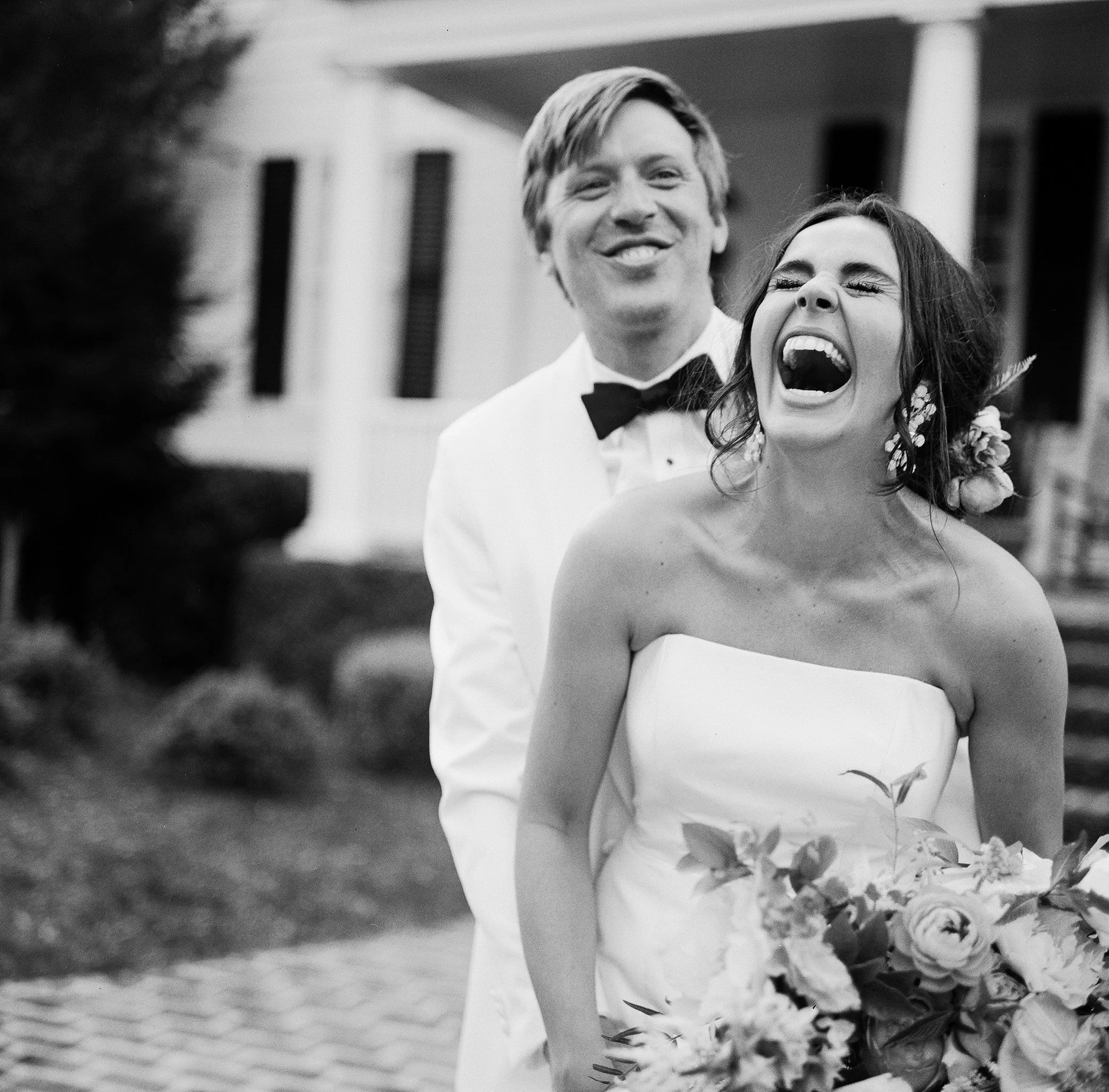 Couple laughing during portraits on their wedding day at Litchfield Plantation