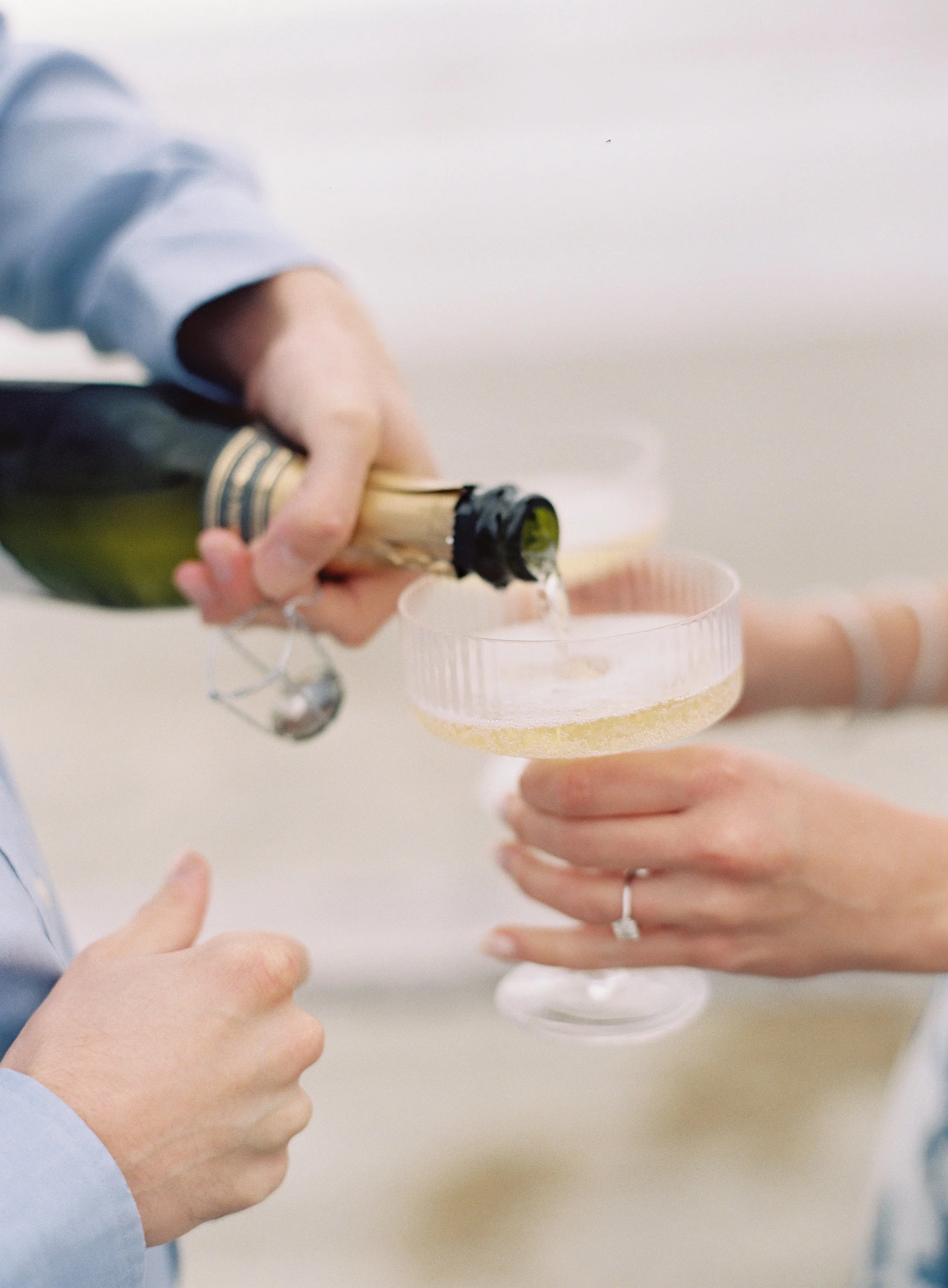 Newly engaged couple sharing champagne at the Ocean Course on Kiawah Island