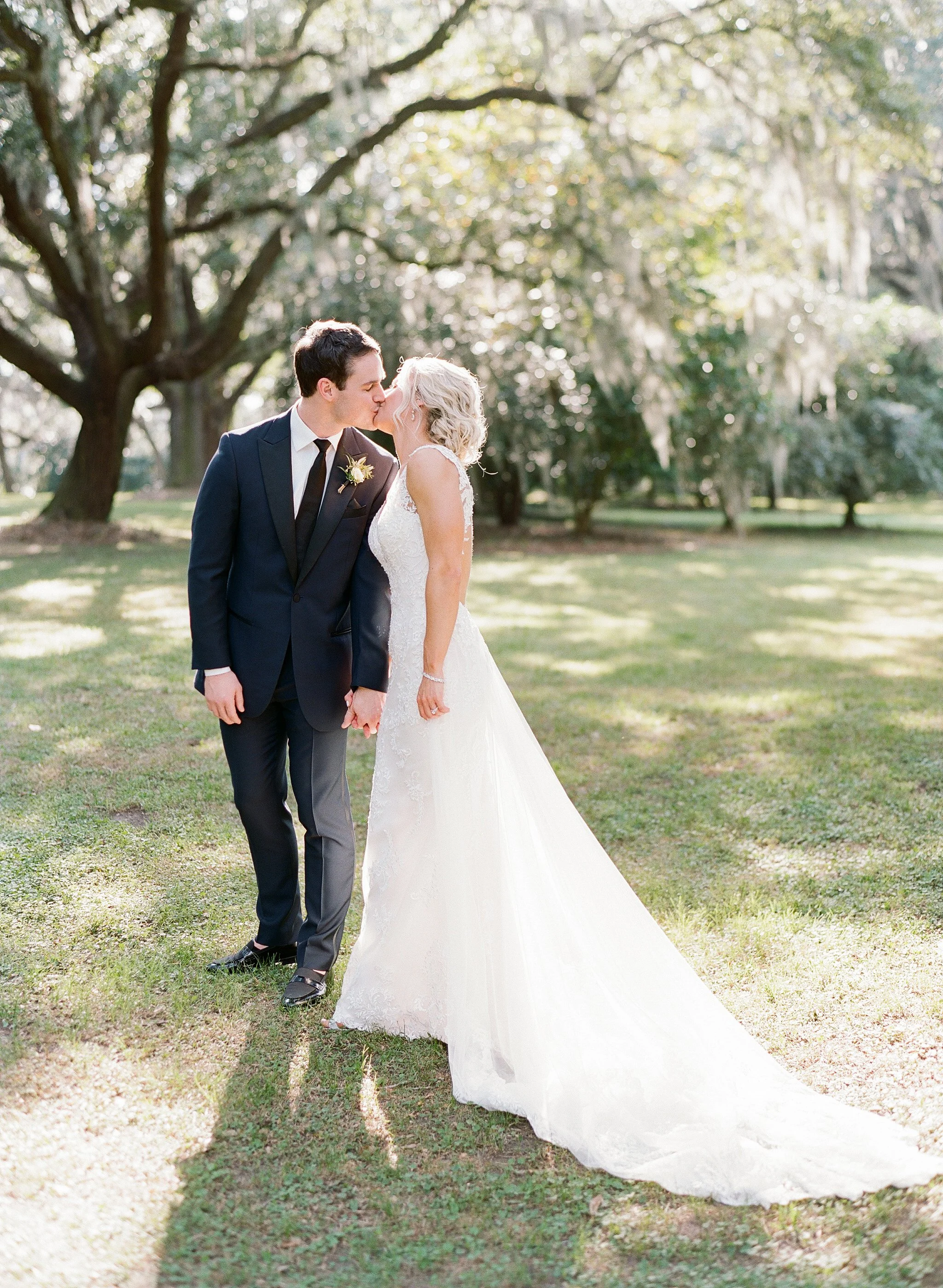 Bride and groom under Spanish moss at Legare Waring House Charleston