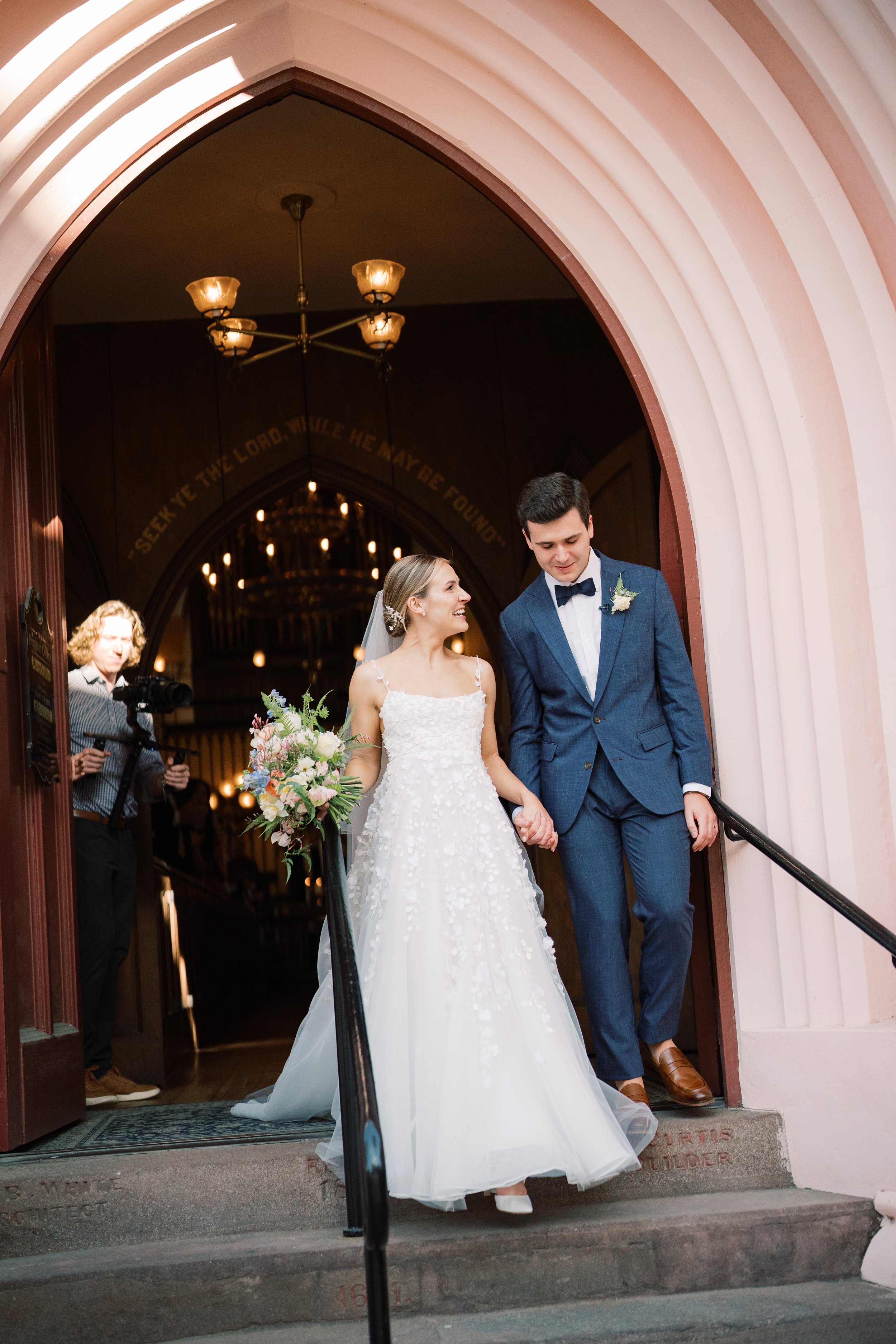 Bride and groom portrait in front of historic French huguenot church entrance