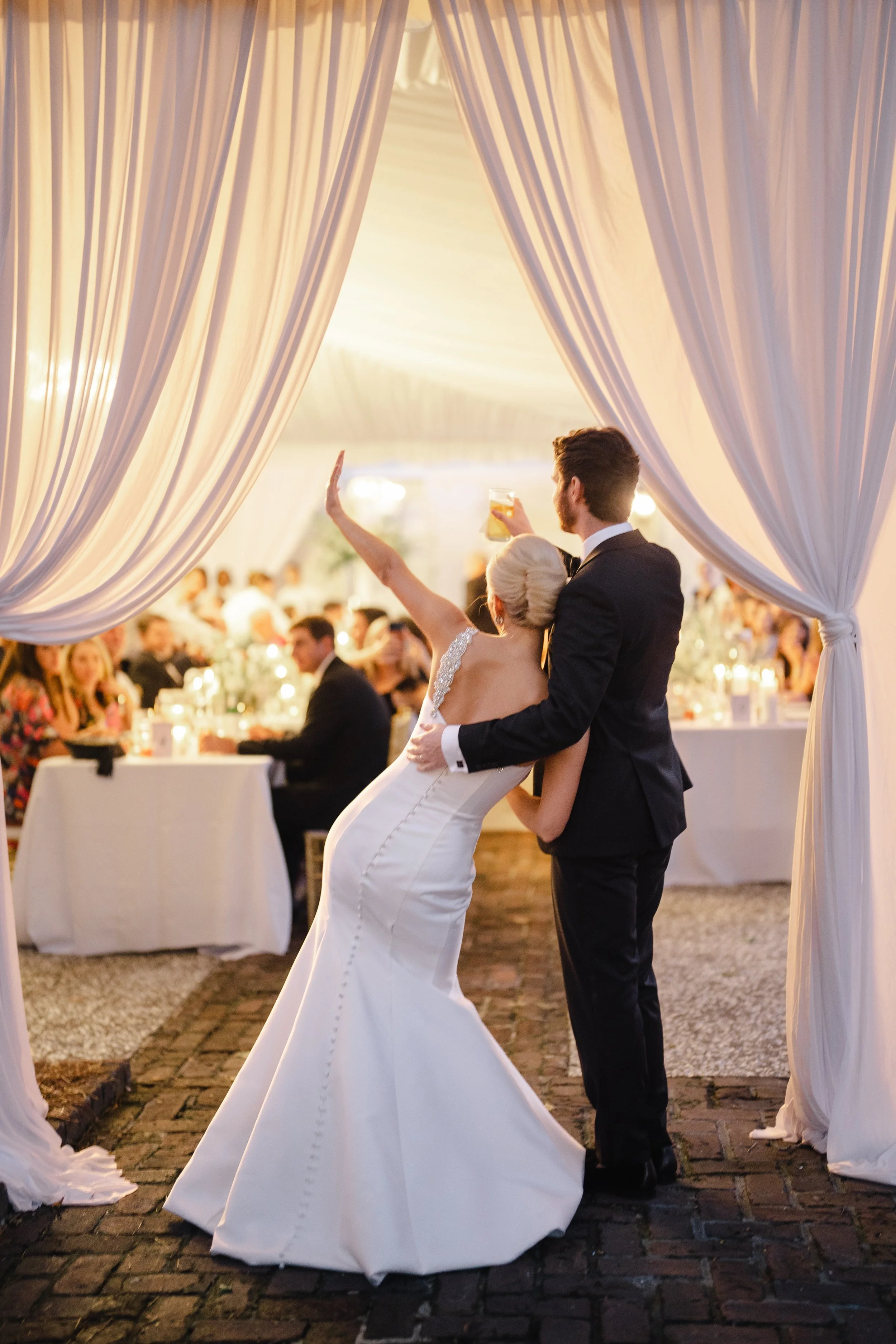 Bride and groom entering reception at William Aiken House wedding in Charleston South Carolina