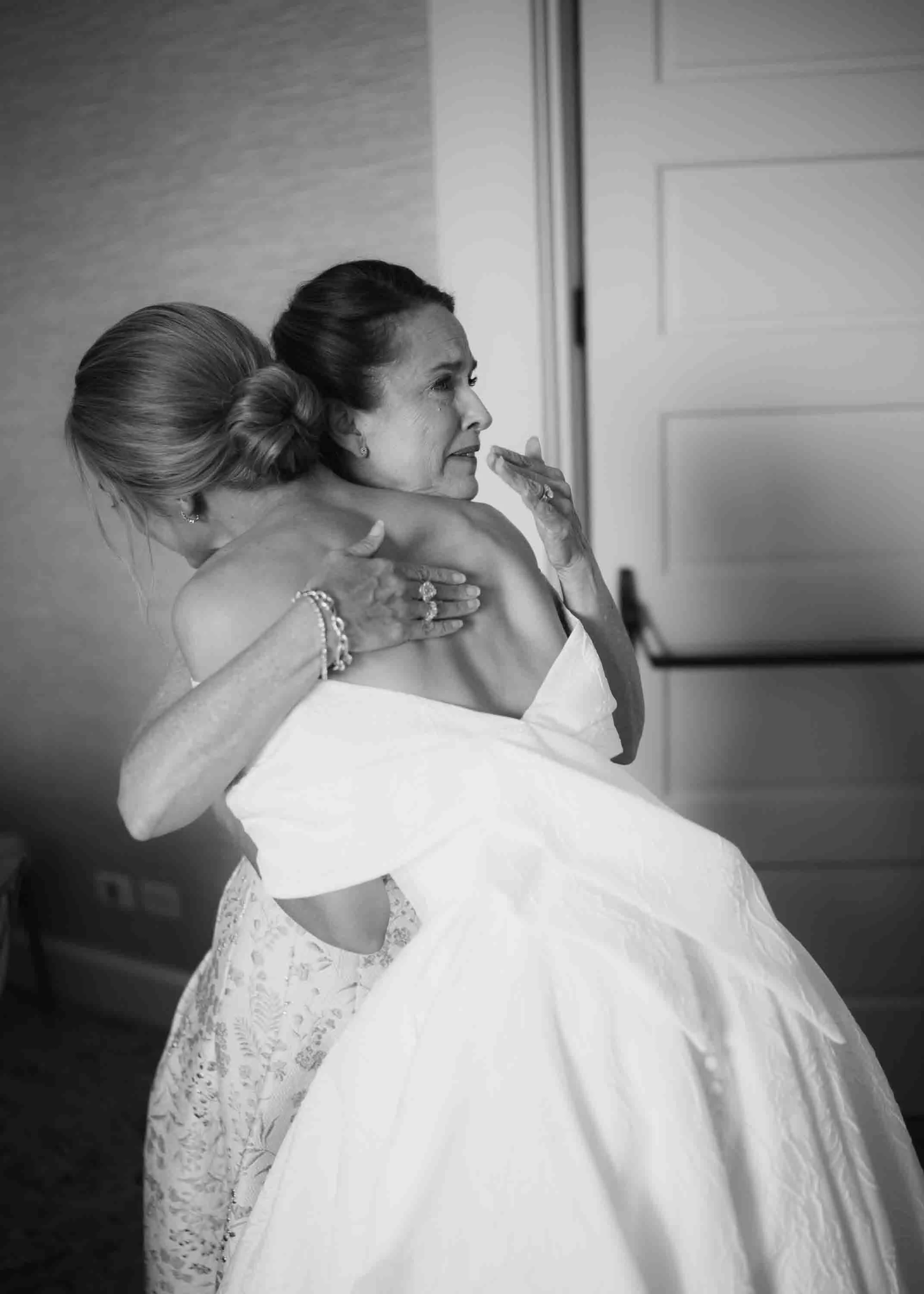 bride hugging mother getting ready emotional wedding moment kiawah island
