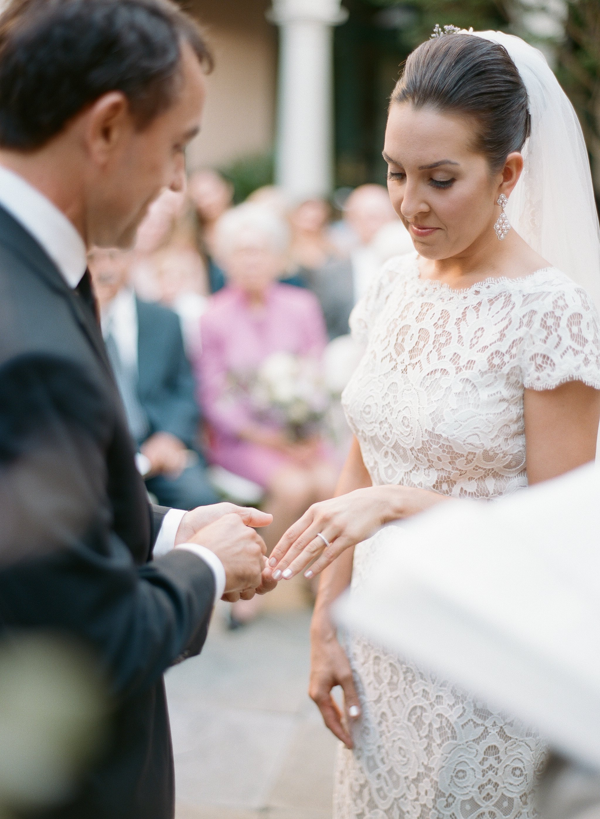 Groom gives bride ring during wedding ceremony at the Planters Inn