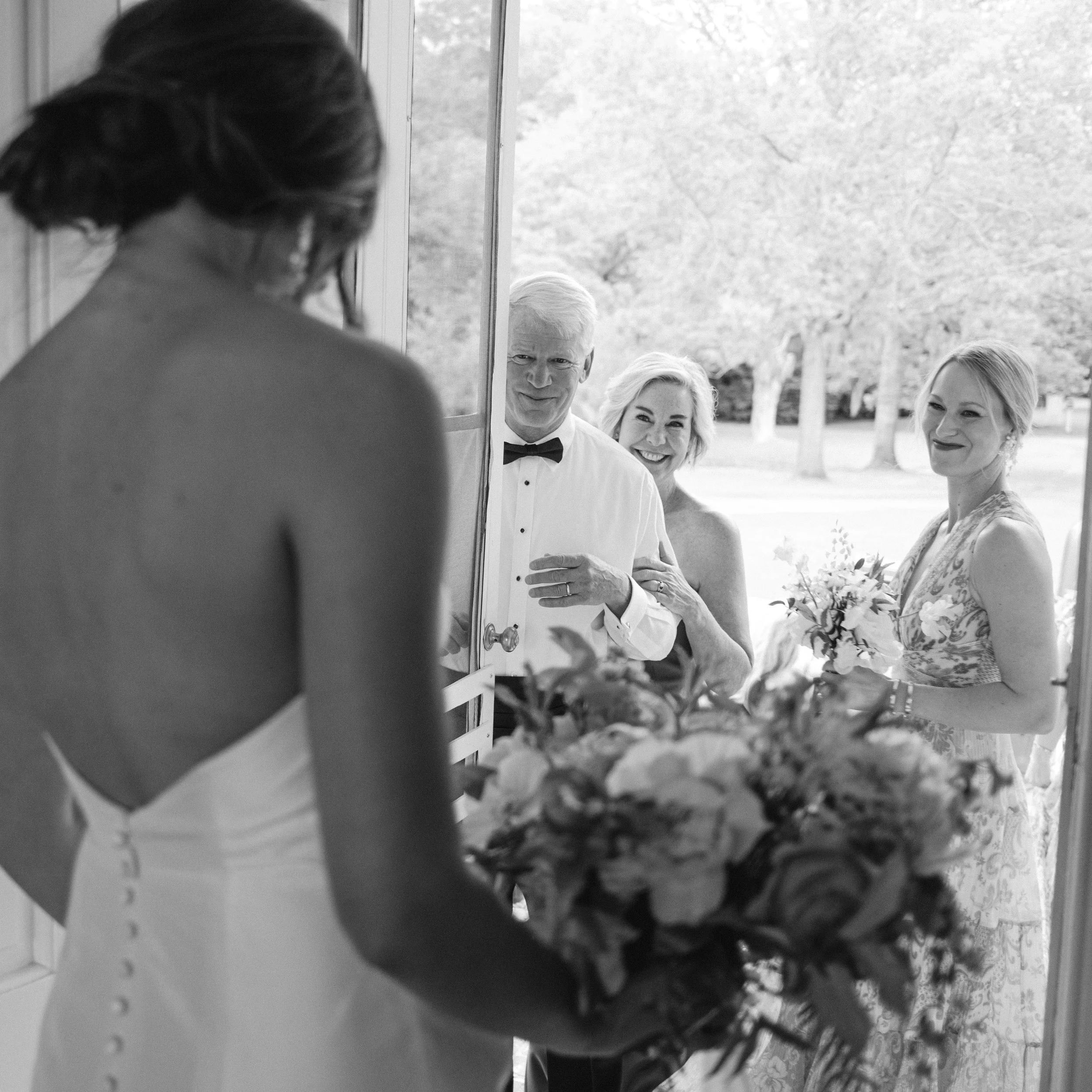 Bride seeing the groom’s family for the first time at Litchfield Plantation wedding in South Carolina