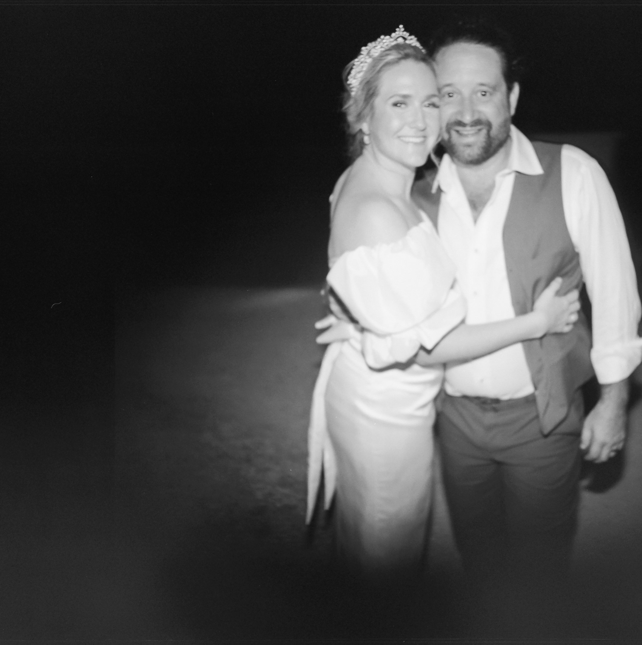 Bride and groom embracing during an evening celebration at Villa Pianciani in Umbria, Italy.