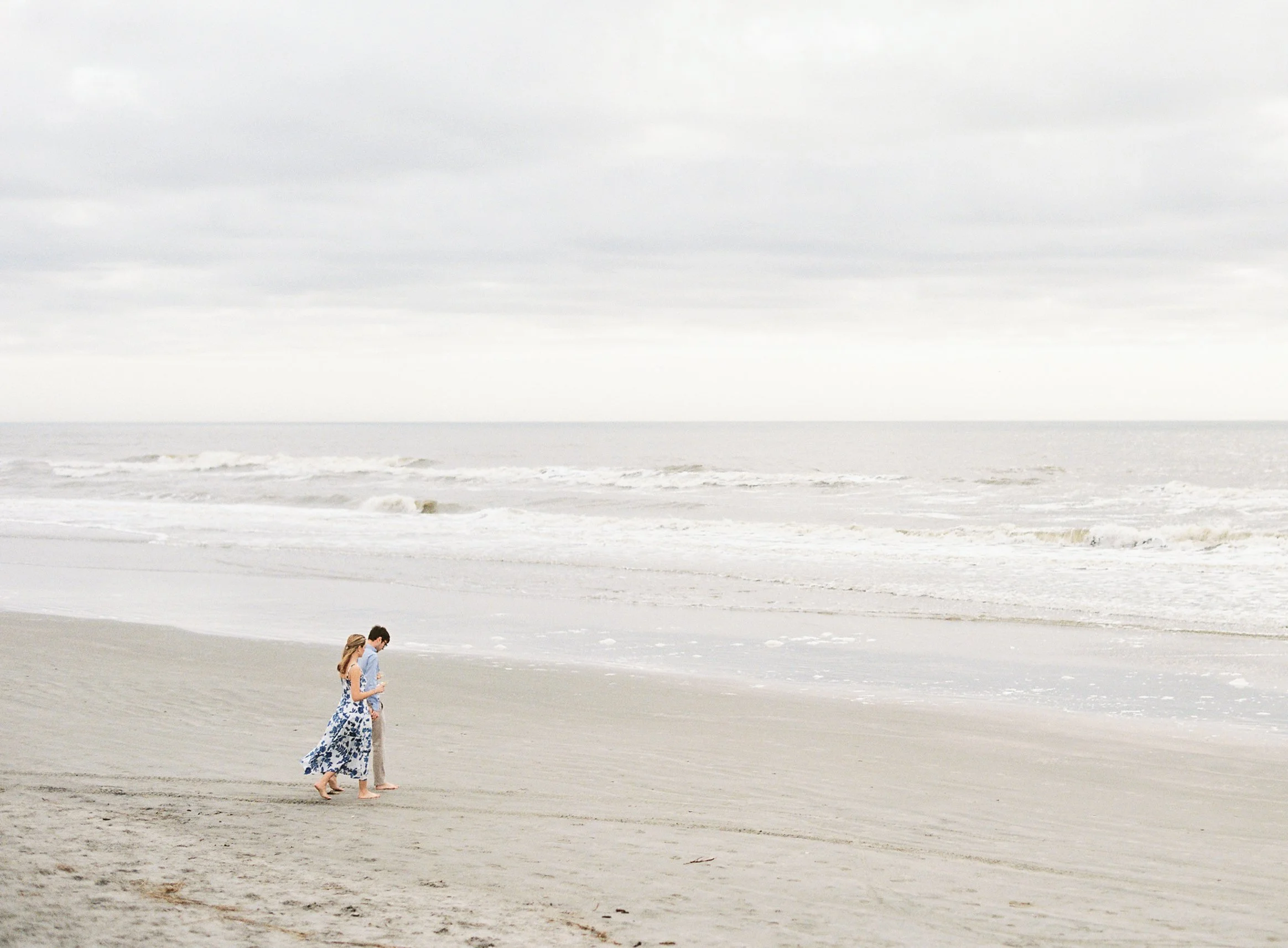Couple walking barefoot on Kiawah Island shoreline