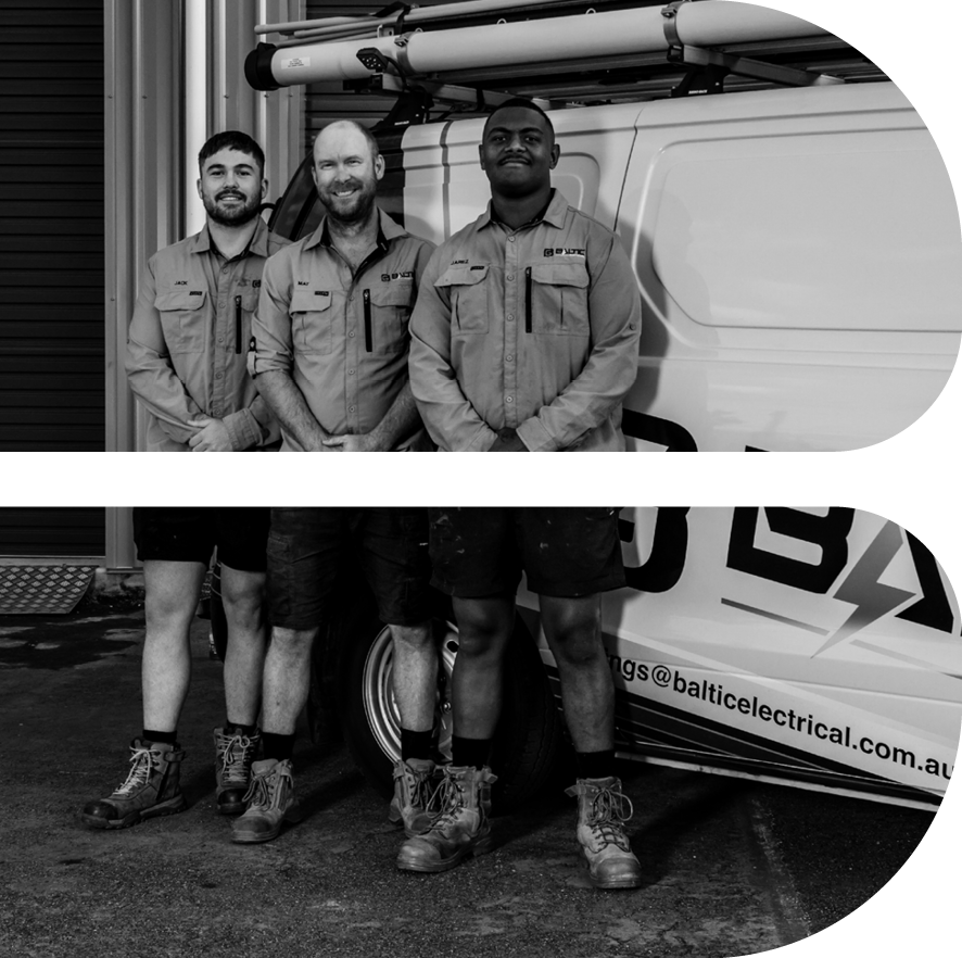 Three men in work uniforms standing in front of a van with a company logo and email address, wearing boots and posing for a group photo.