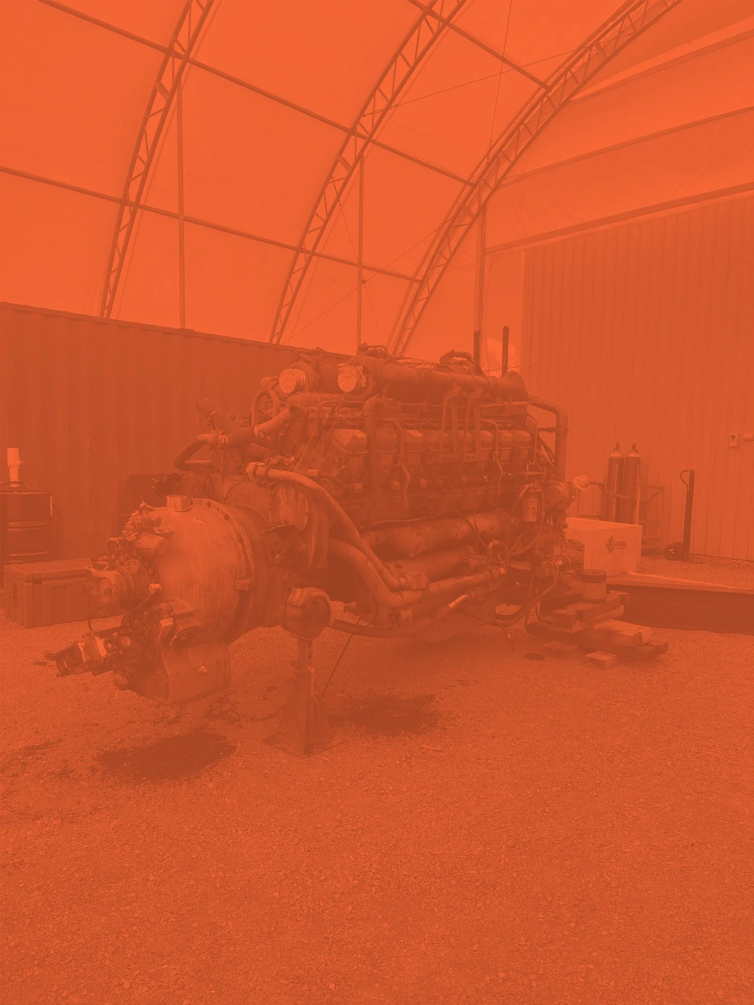 Large industrial engine inside a tented structure