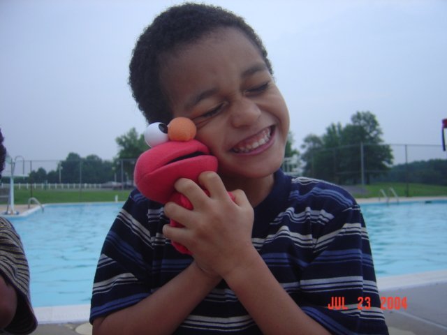 Emanuel with Brianna's old Elmo toy.JPG