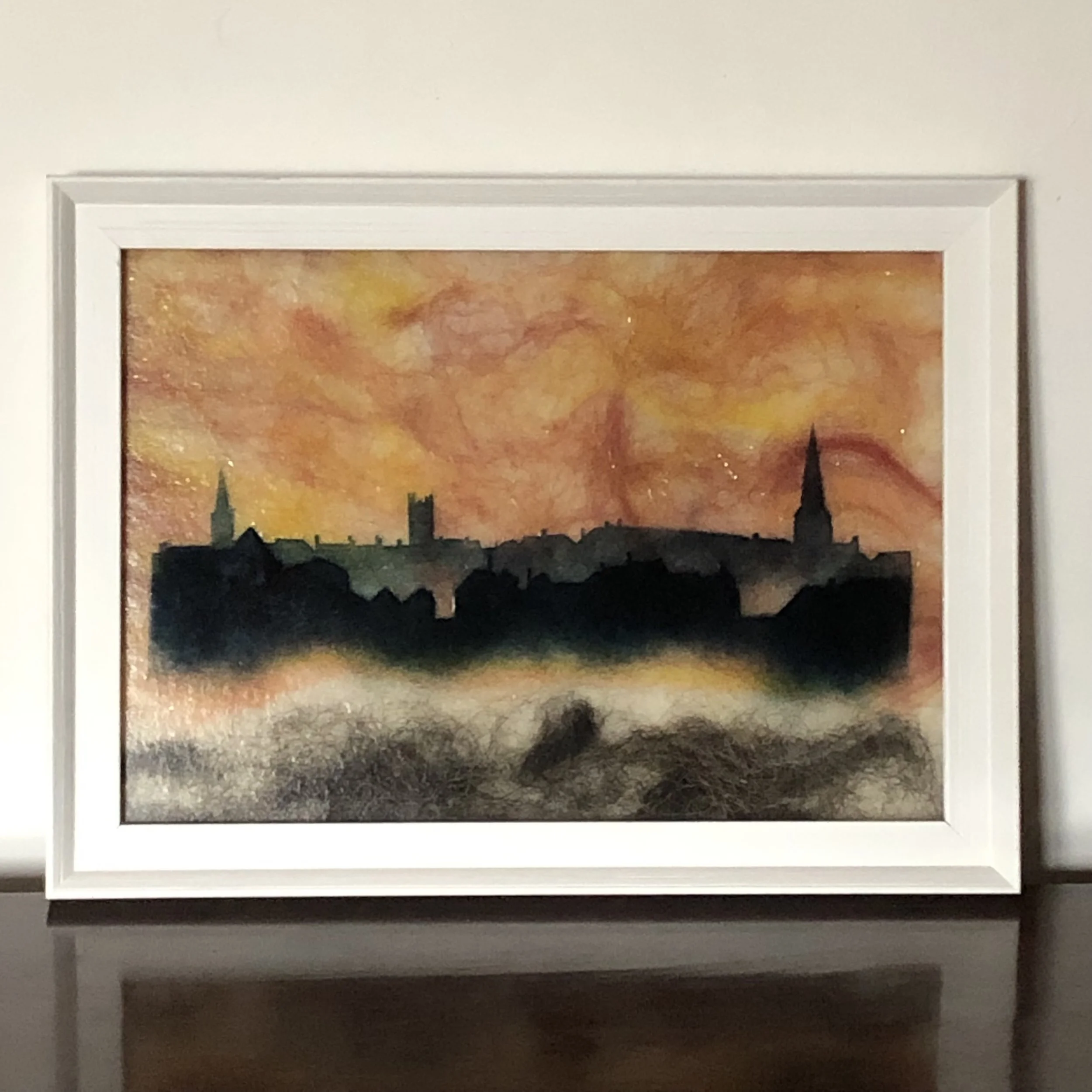 Stamford Skyline from the Meadows. Fused glass skyline using hand-cut stencils and powdered glass, background felted wool