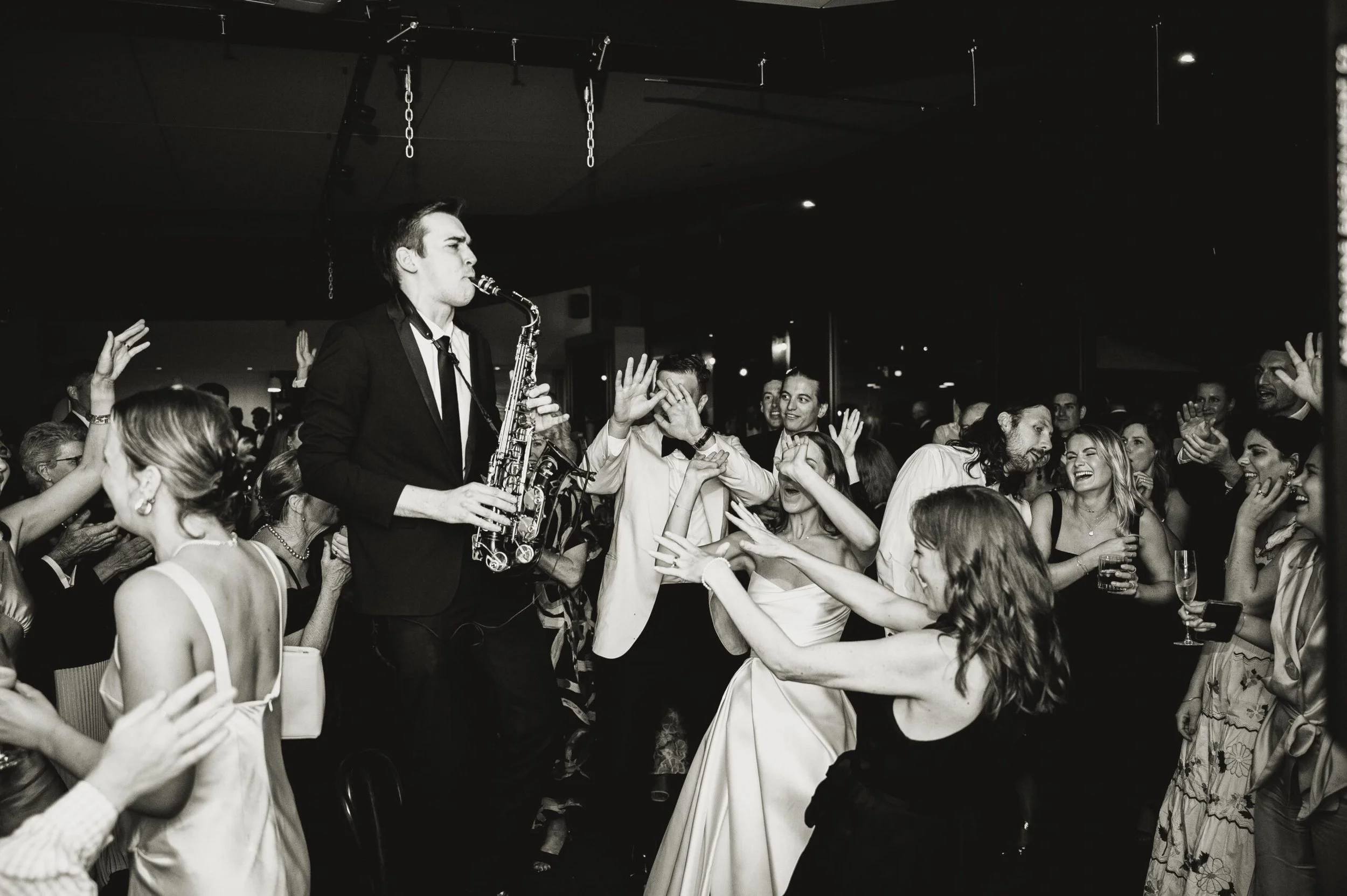 A man performing a song on a saxophone at a wedding