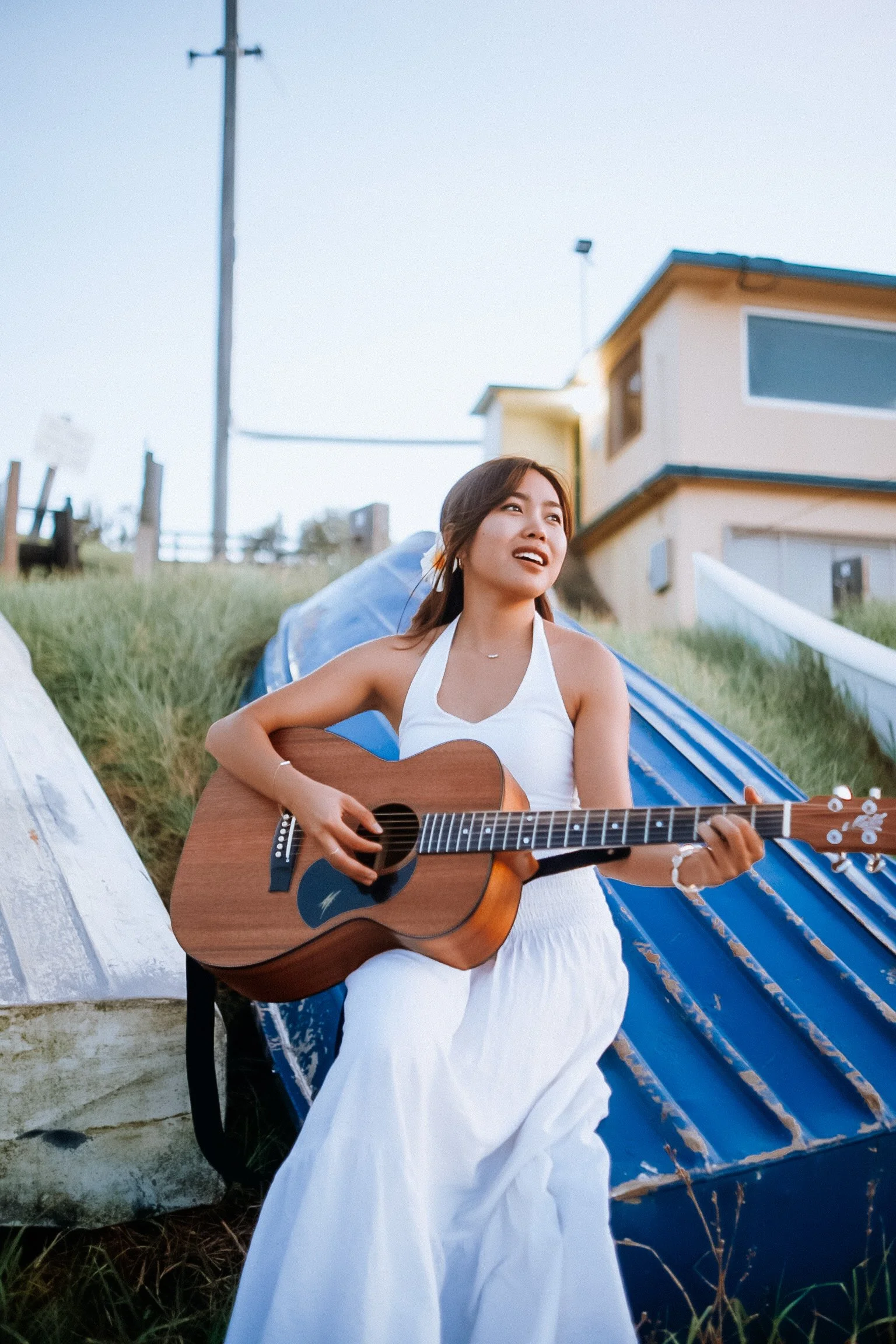 Ve holding a guitar on a boat
