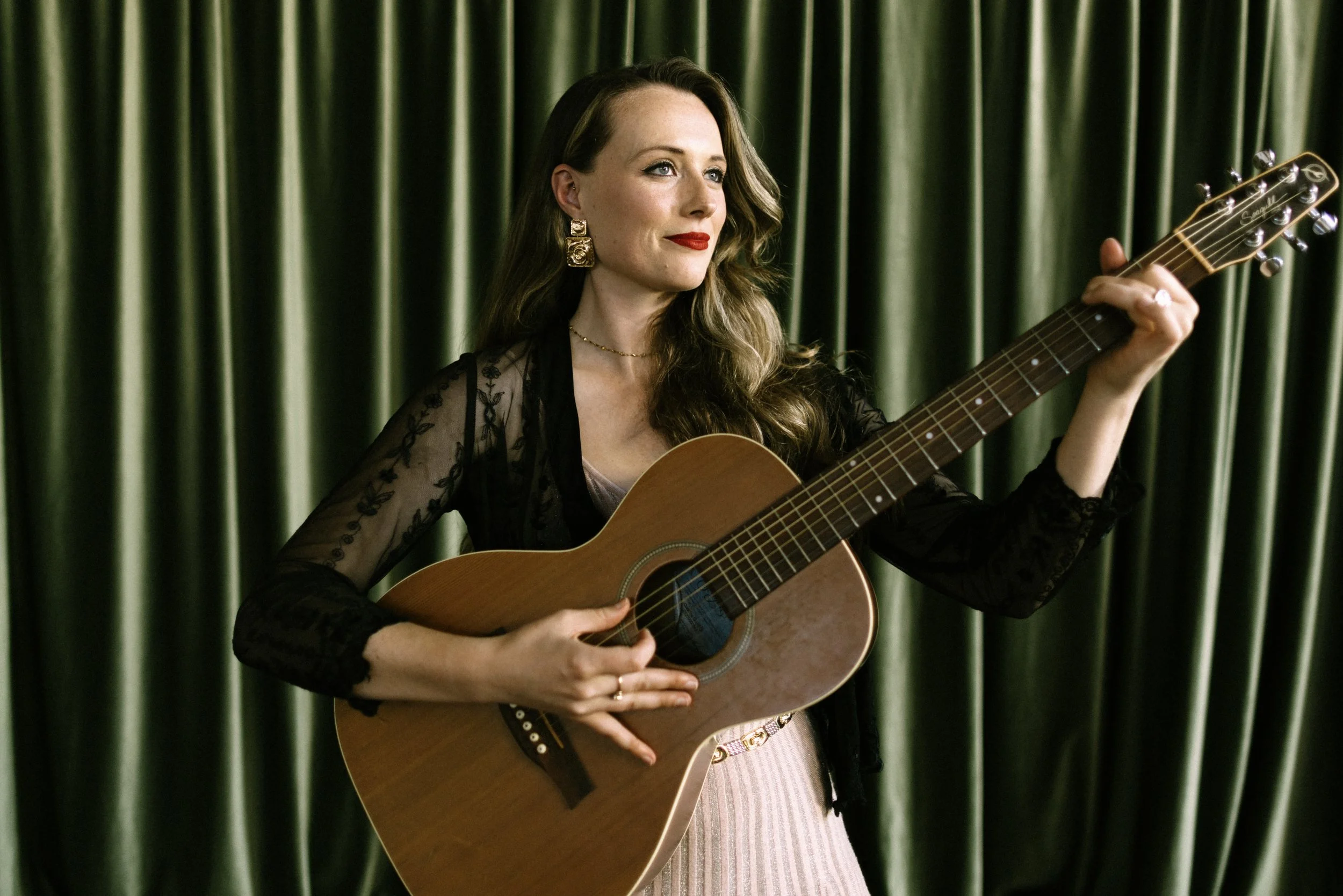 A woman holding a guitar