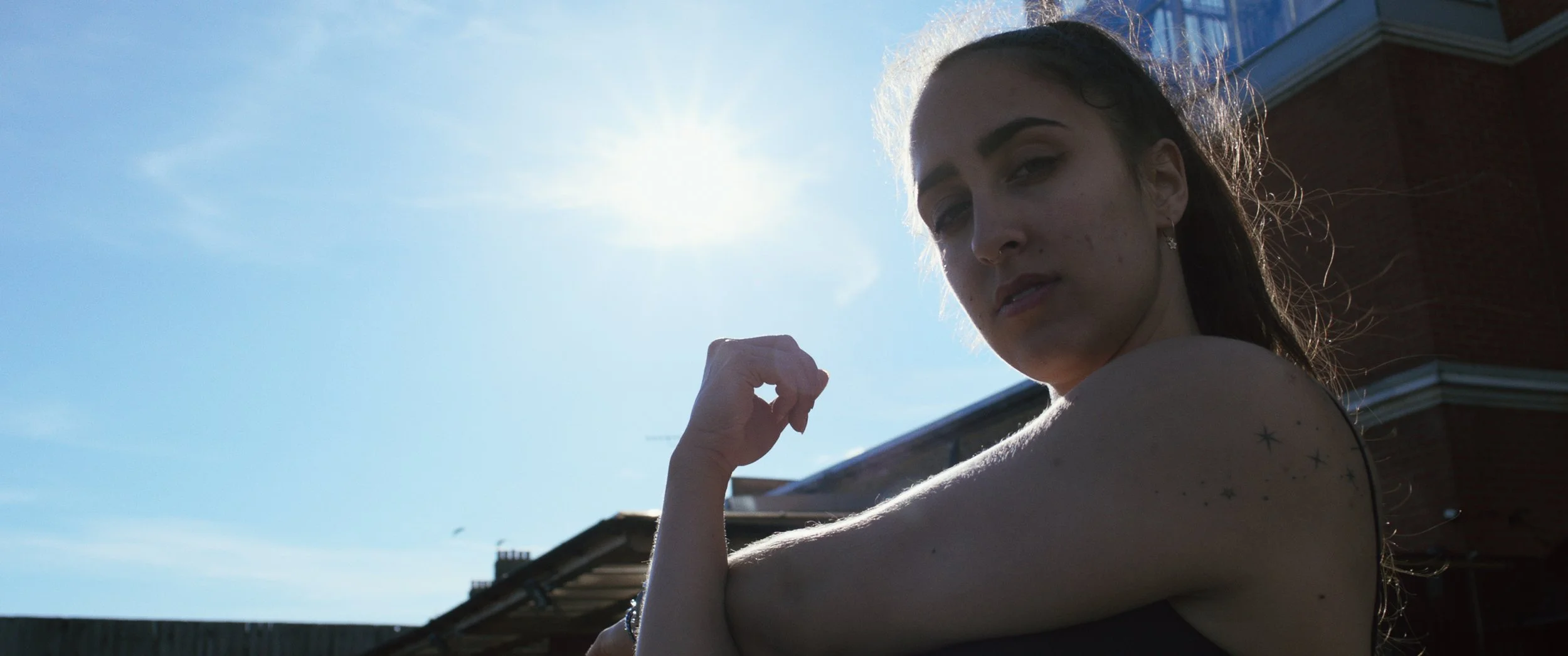 Hajnalka Balazs (Hajni) stretched her left shoulder as the sun shines in a blue sky, Easy