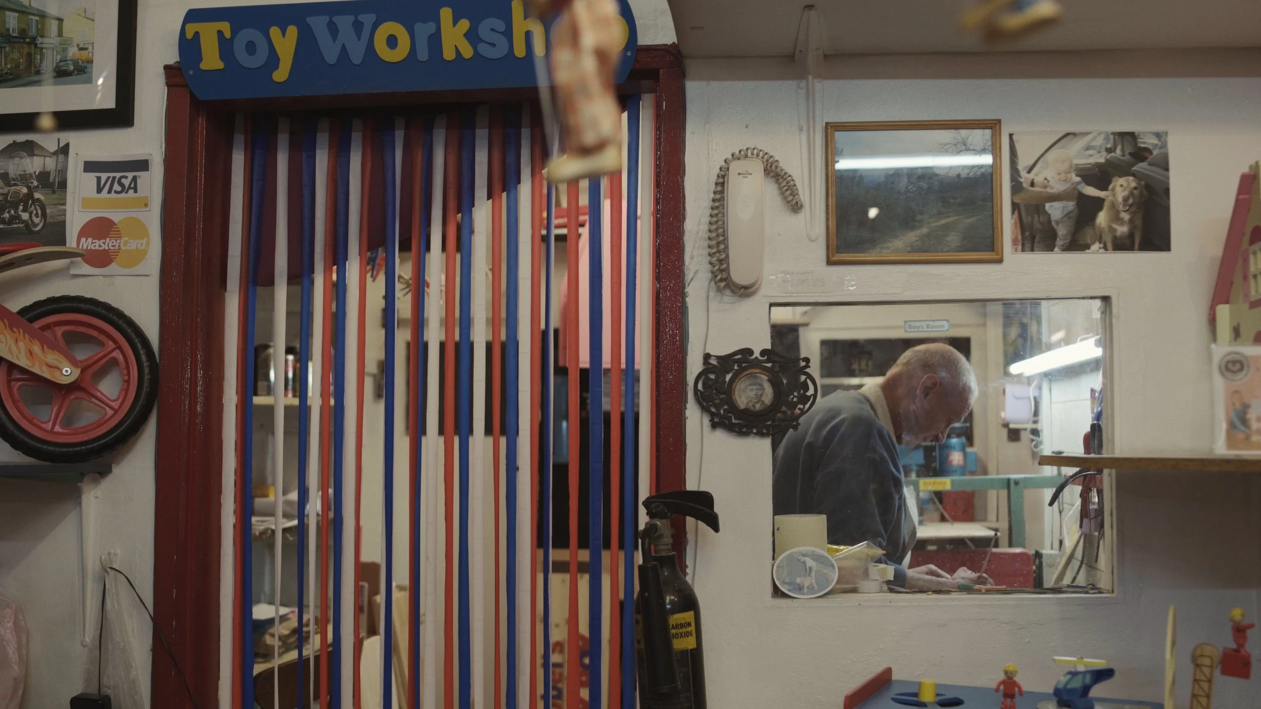 An elderly man works as his workbench in his "Toy Workshop", The Last Toymaker