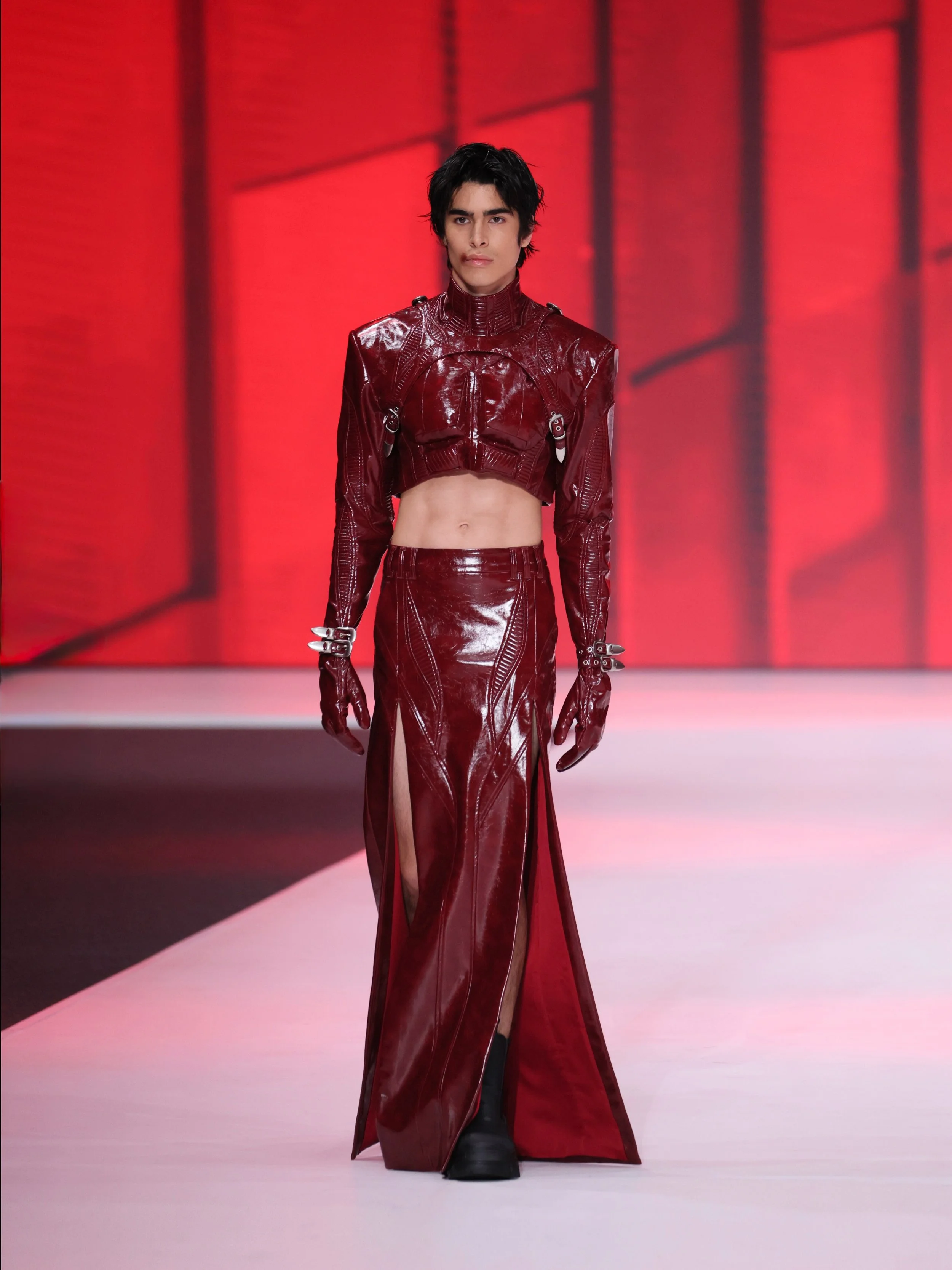 ANGUS TSUI SS27 ‣
/ 404: Ha Ha Haunting / Look 4 ‣ 

He wears his skin like a second hide. 

Red-skinned leather molds a high neck top with puffed, exaggerated chest muscles and defined upper abs - a torso that looks carved rather than born. The harn
