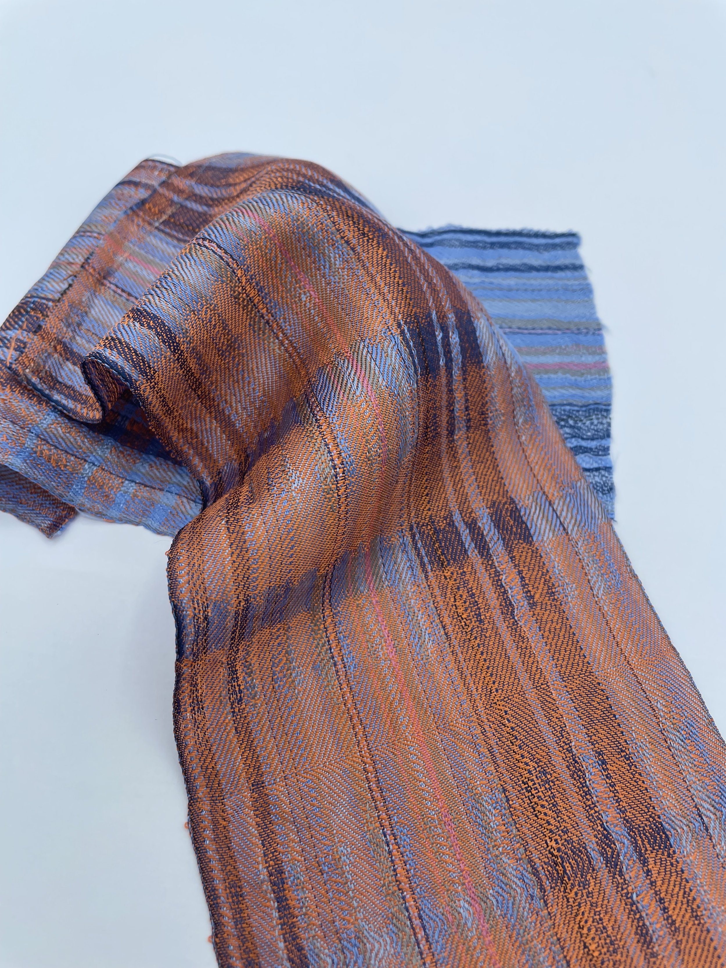 Handwoven silk samples displayed to show drape and shine