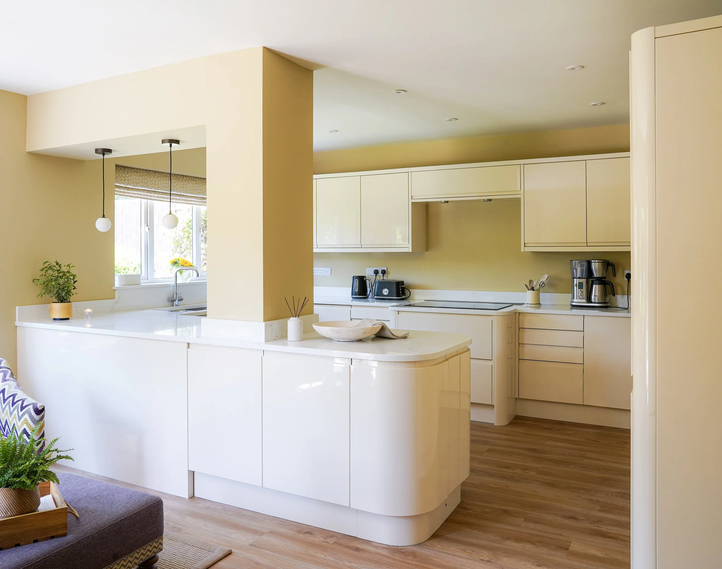 Cream gloss kitchen with Farrow and Ball Cord walls and white quartz worktop