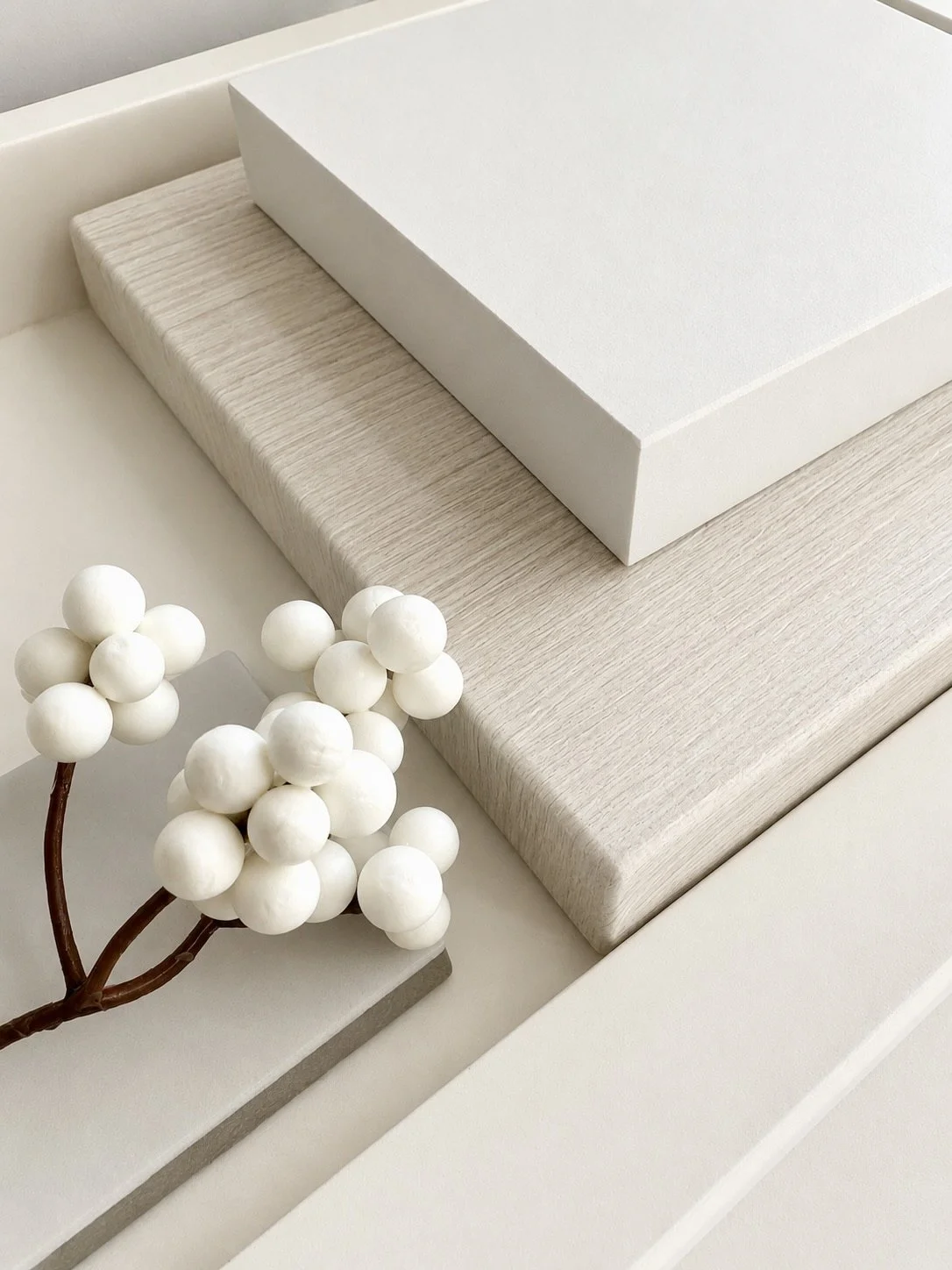 Glossy white marble against pale white wood wash, showing two textures in one shade of white