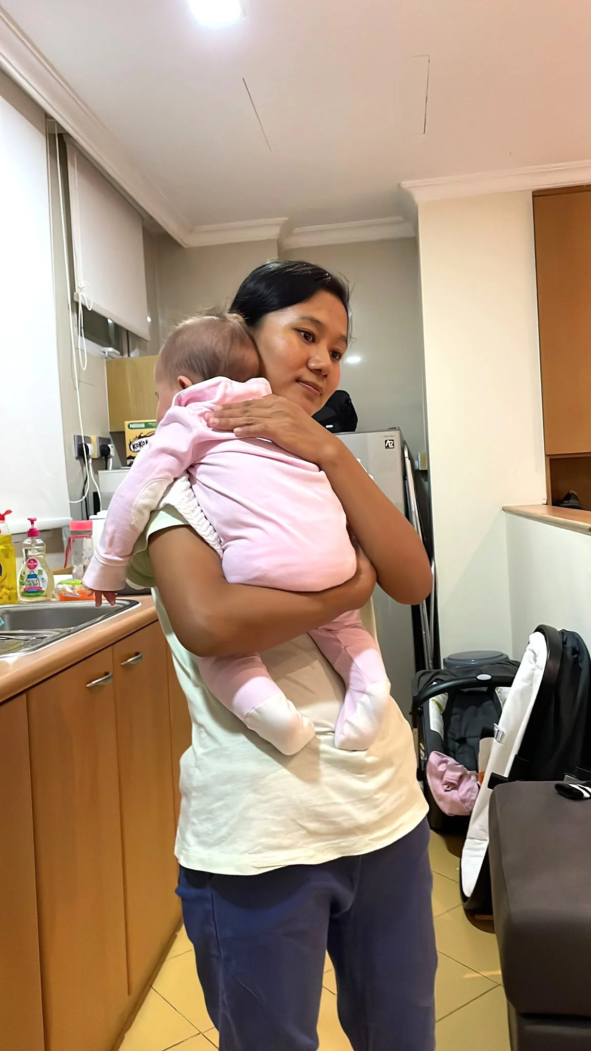 Myanmar Helper / Maid taking care of baby